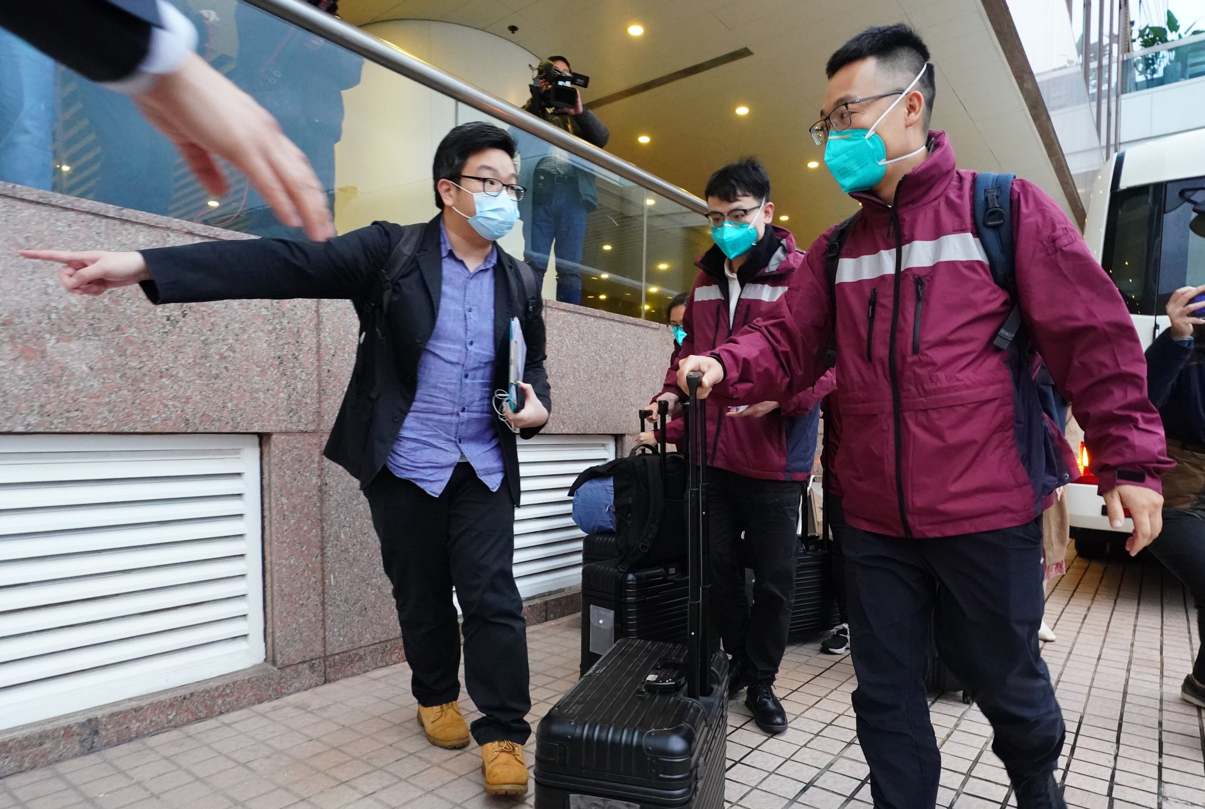 Medical experts, including Kang Min (right), head of the infectious disease institute under the Guangdong Provincial Centre for Disease Control and Prevention, arrive at The Gateway in Tsim Sha Tsui, in Hong Kong, on February 17. Photo: Felix Wong