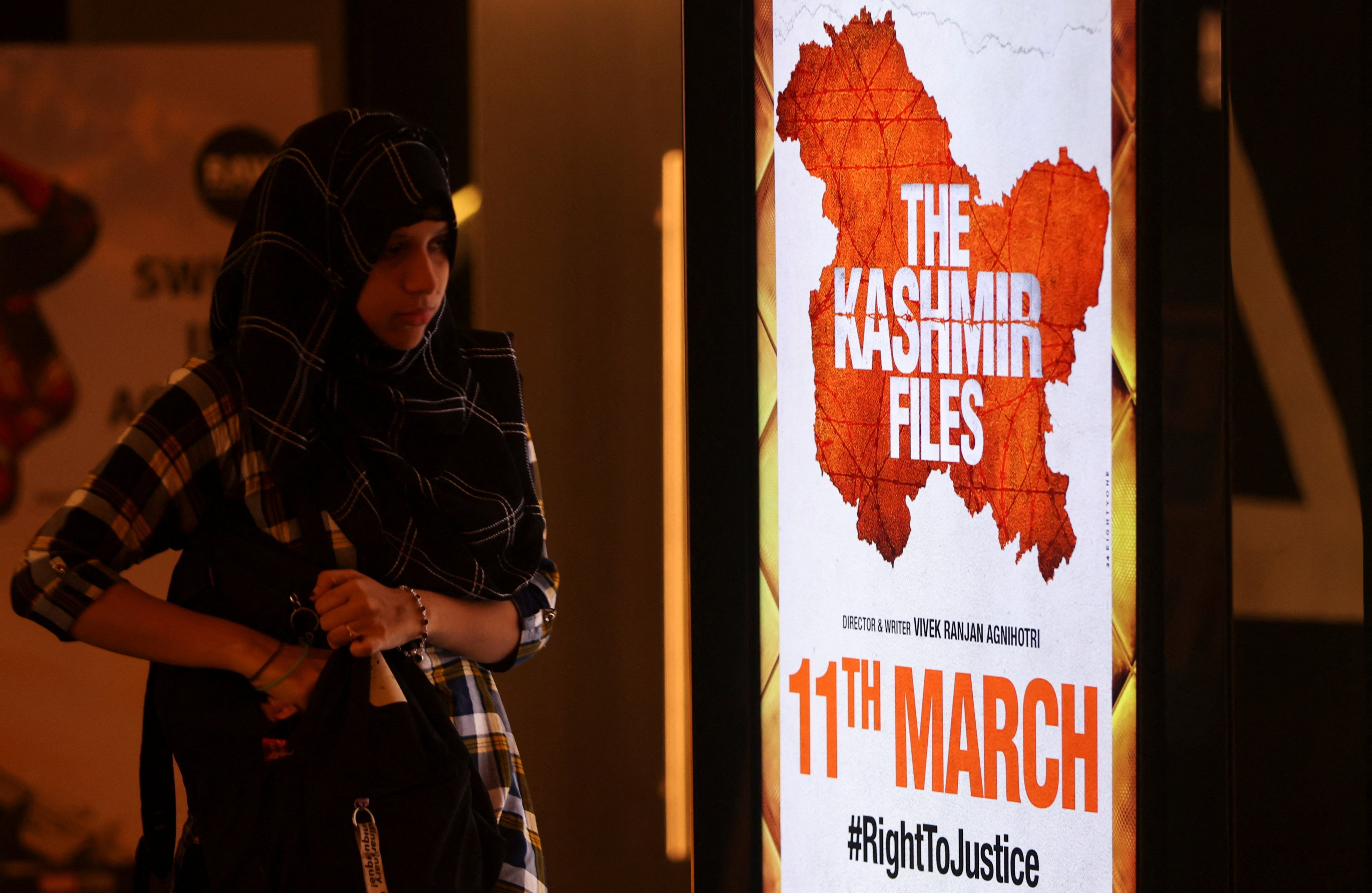 A woman walks past a poster for “The Kashmir Files” inside a cinema in Mumbai last week. Photo: Reuters