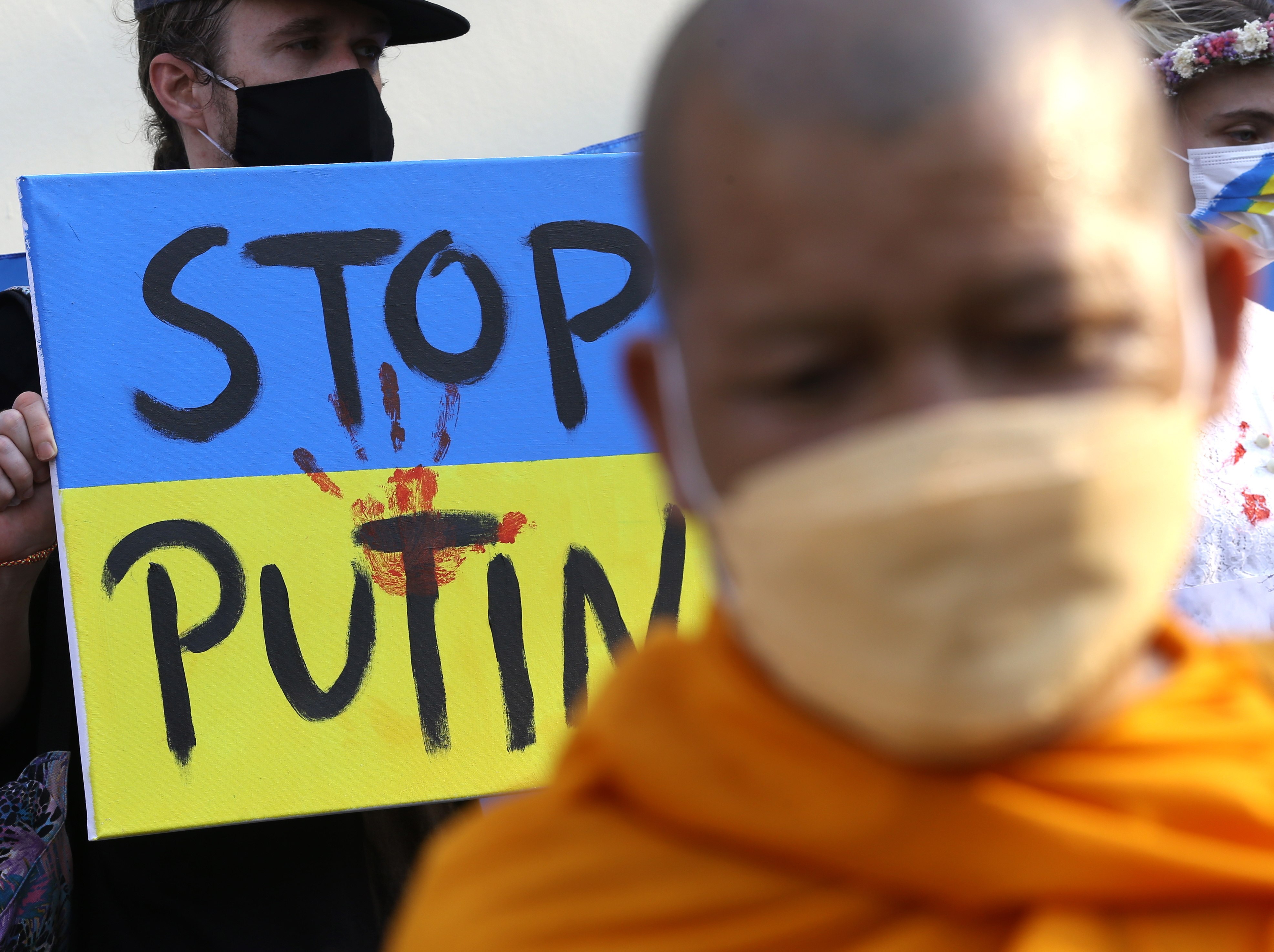 A Thai Buddhist monk stands with Ukrainians living in Bangkok during a protest against Russia’s invasion earlier this month. Photo: EPA