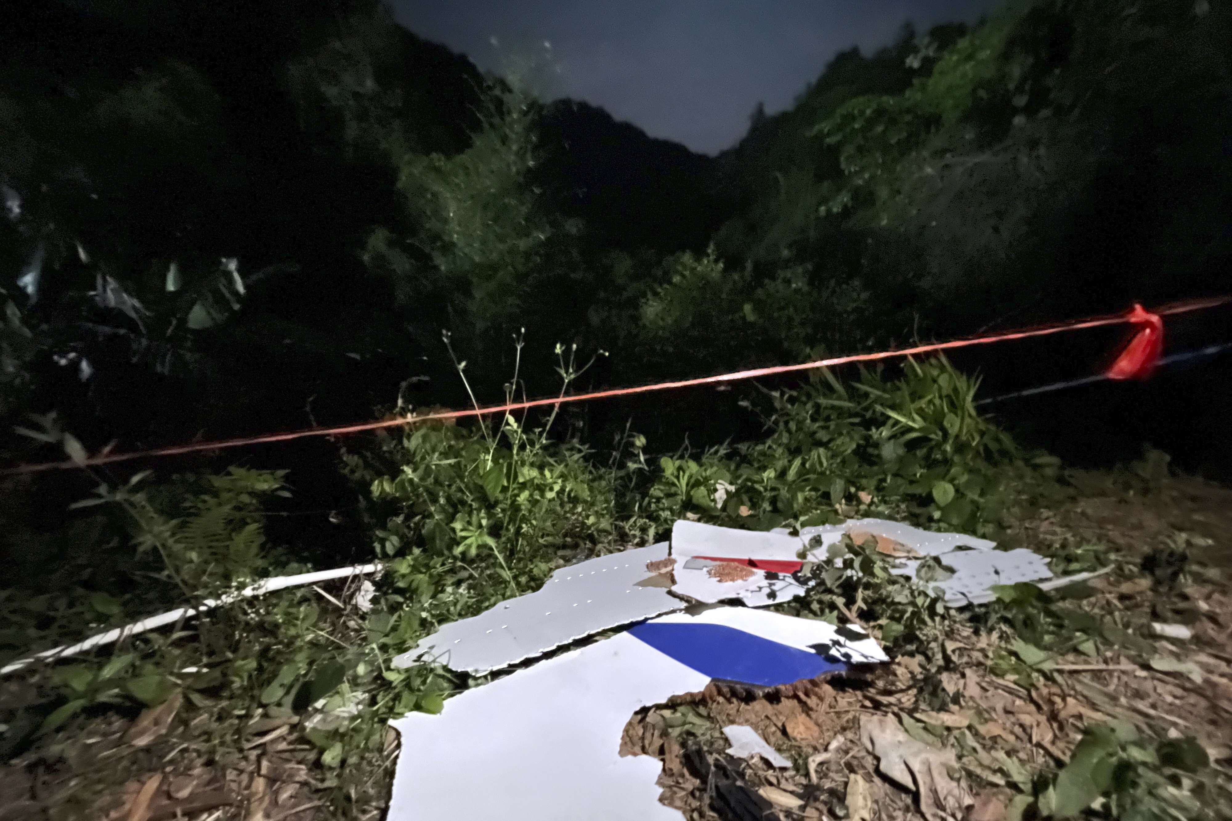Debris is seen near the site where a China Eastern Boeing 737-800 crashed in southern China. Photo: AP