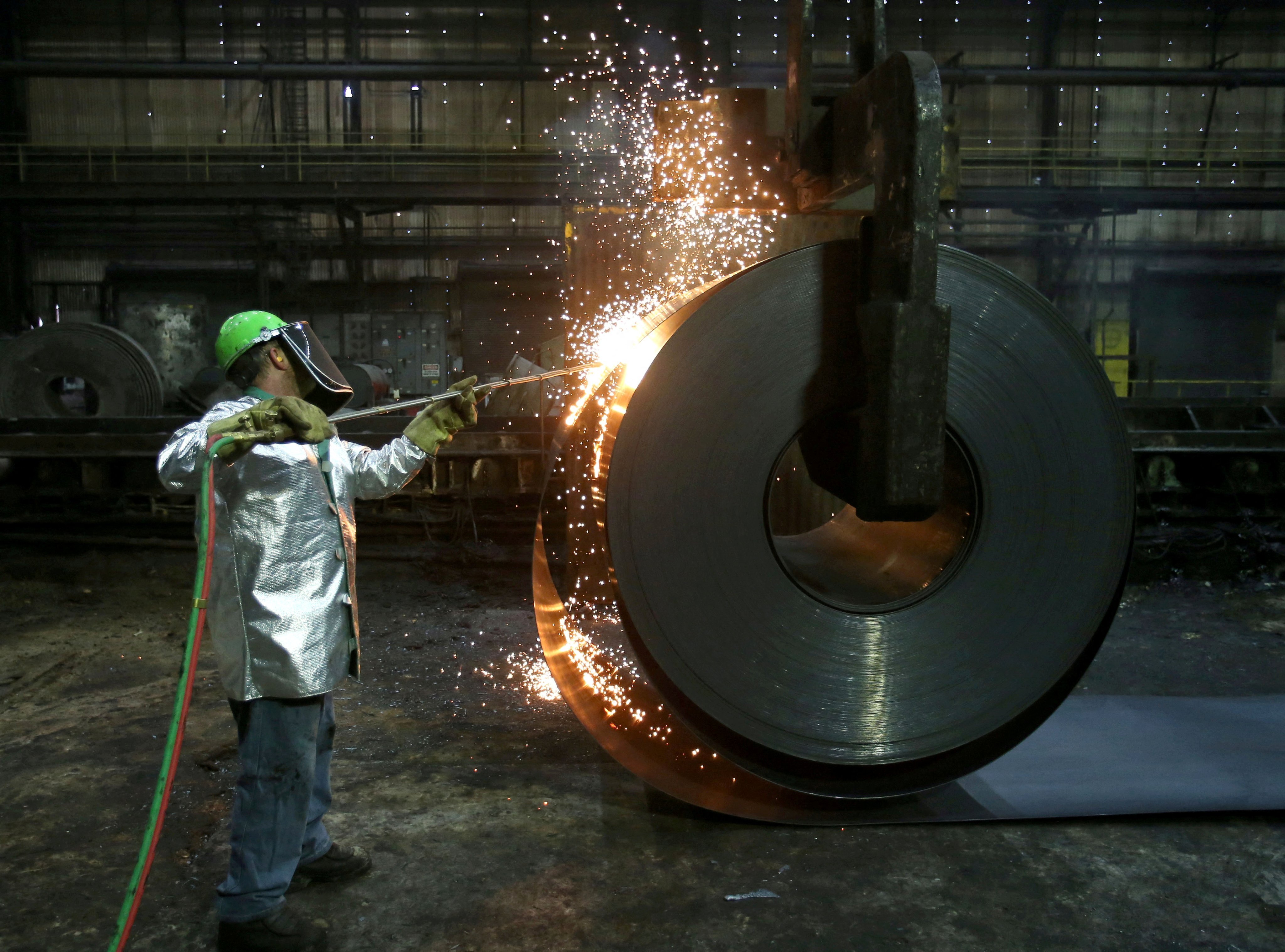A worker cuts a piece from a steel coil at the Novolipetsk Steel PAO steel mill in Farrell, Pennsylvania, in March 2018. Photo: Reuters