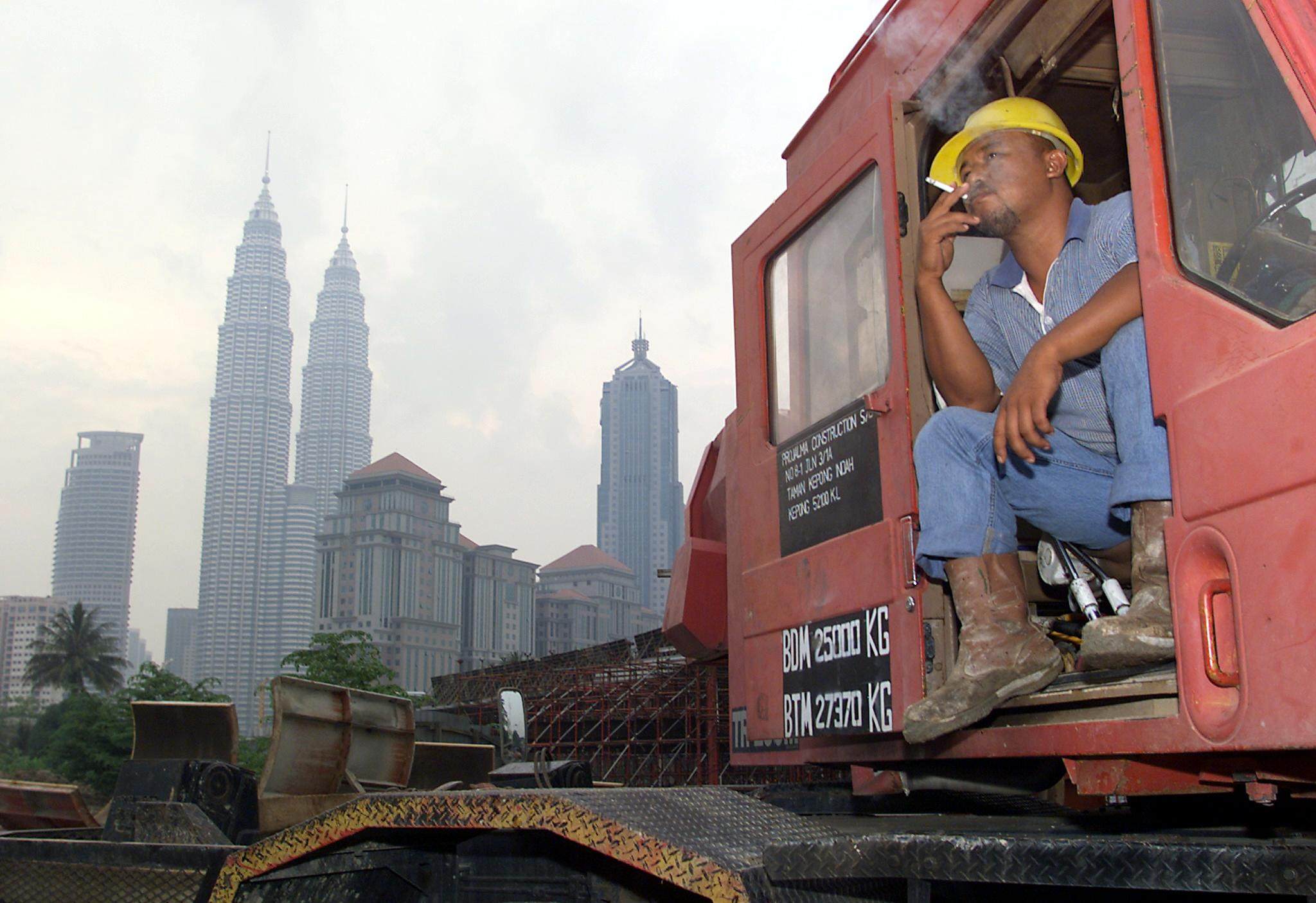 A construction worker takes a smoke break in Kuala Lumpur. File photo: AFP 