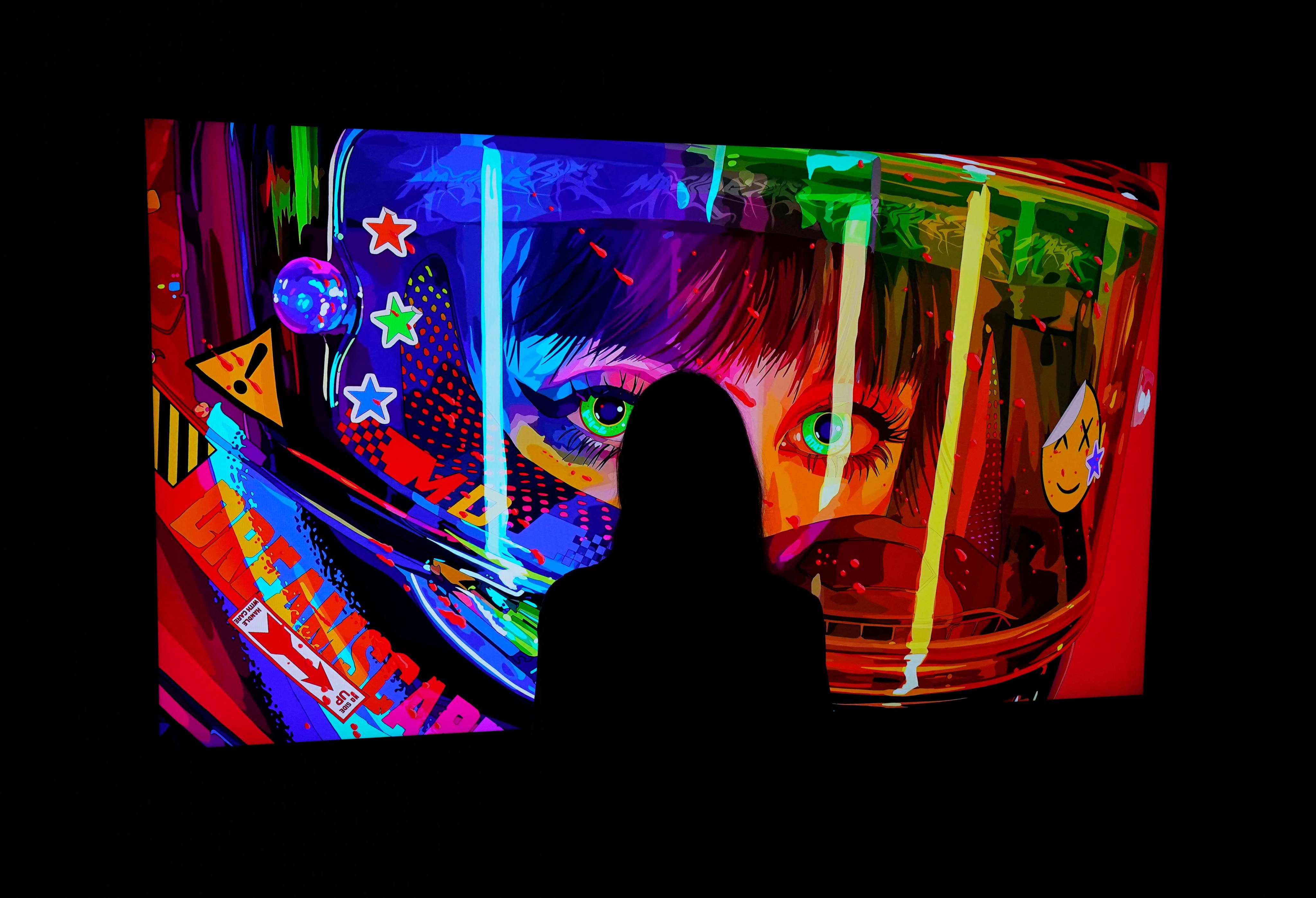 A woman looks at an NFT by Mad Dog Jones titled  “SHIFT//“ at the Natively Digital: A Curated NFT Sale Online Auction hosted by Sotheby’s, on June 4, 2021. Photo: AFP