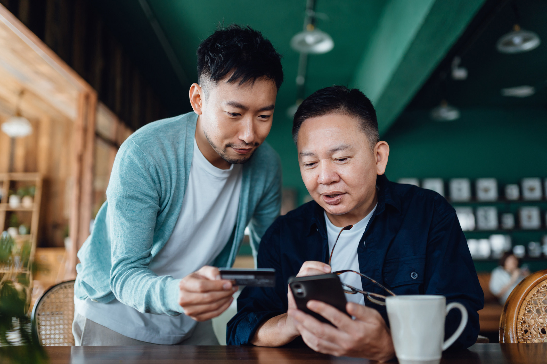 Many Hong Kong residents, including the elderly, have had to embrace digital banking practices because of restrictions on business opening hours and social distancing measures imposed during the Covid-19 pandemic. Photo: Getty Images / AsiaVision