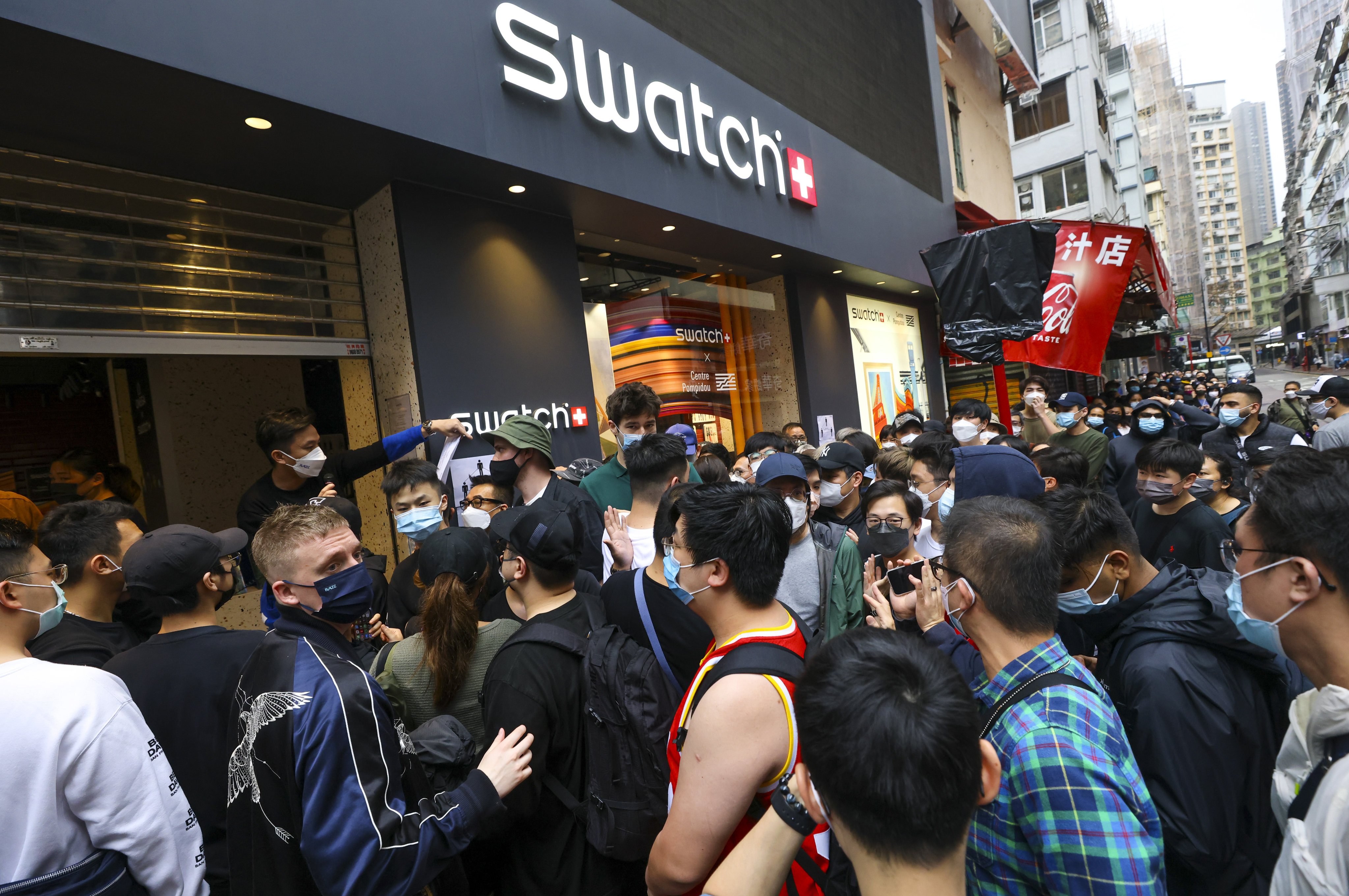 Residents queue up at a Swatch outlet in Causeway Bay on Saturday hoping to get their hands on the Bioceramic MoonSwatch. Photo: Dickson Lee