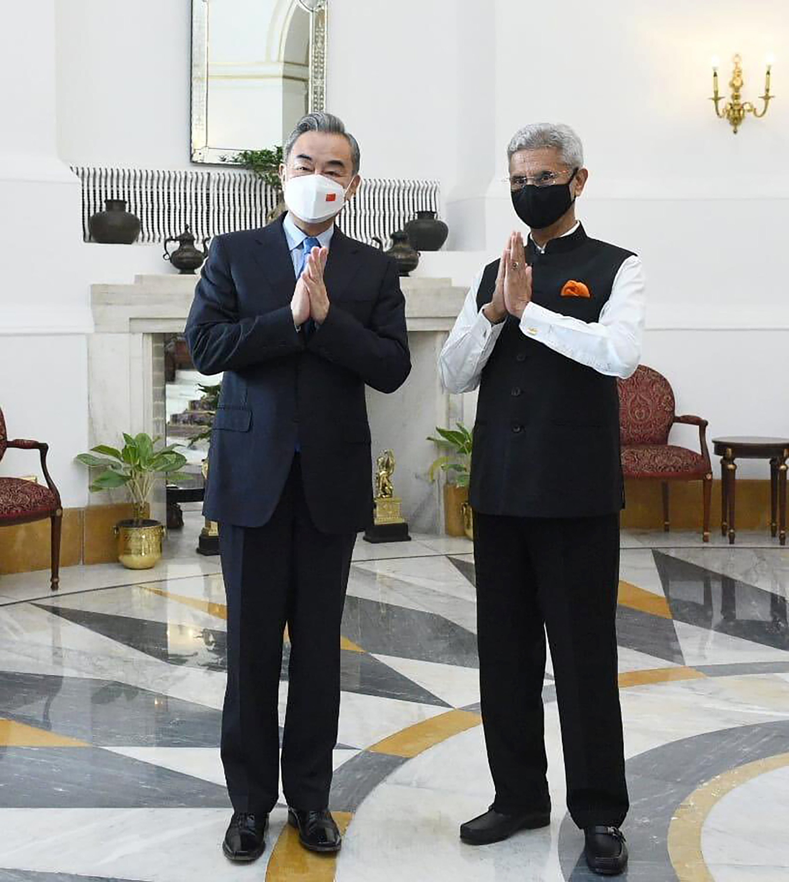 Indian foreign minister S. Jaishankar and his Chinese counterpart Wang Yi greet the media before their meeting in New Delhi, on Friday. Photo: Twitter/@DrSJaishankar via AP