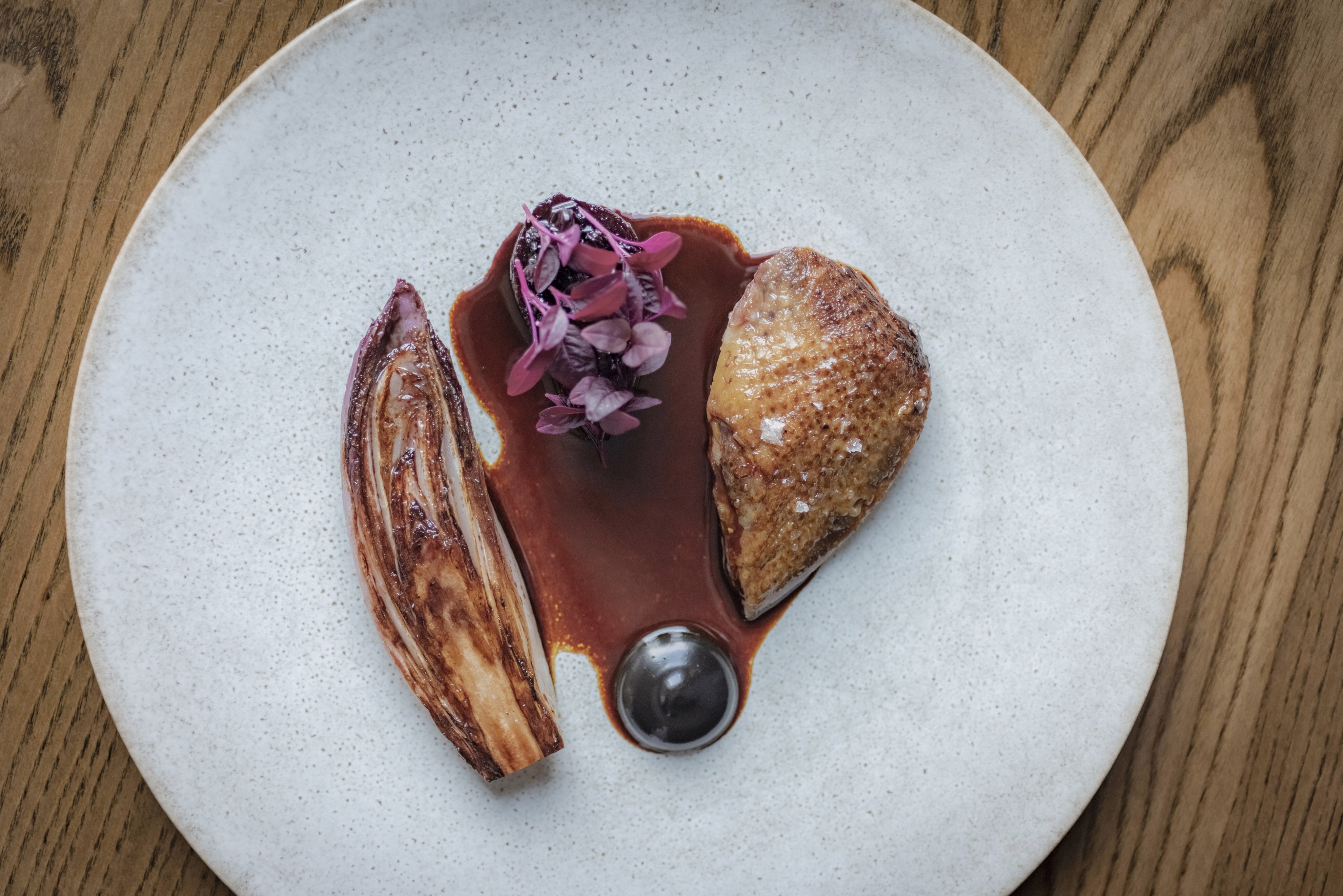 Seven-day hay aged local pigeon with chicory, beetroot and preserved blackcurrant at Roganic. Photo: Handout