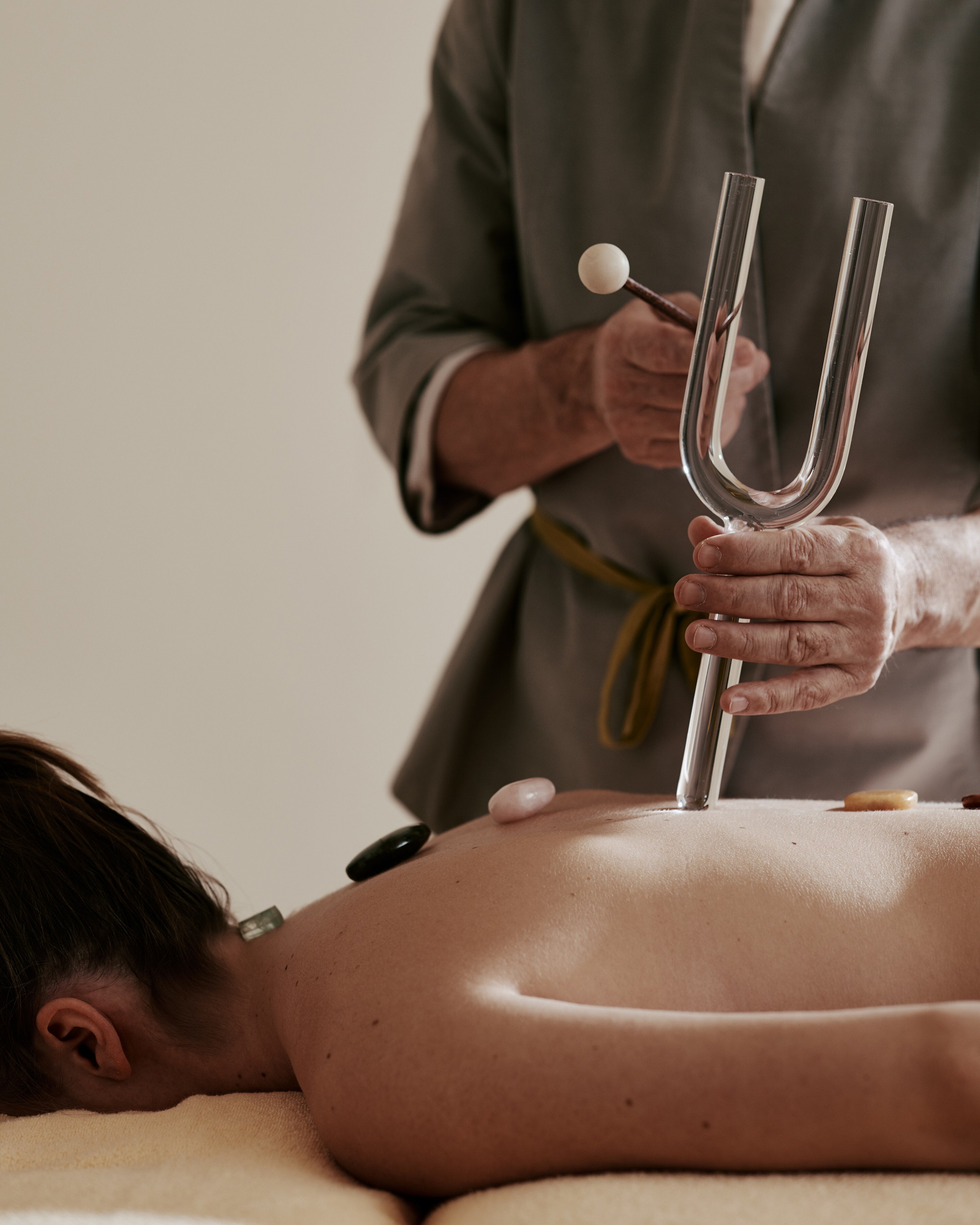 A therapist uses a crystal tuning fork during a sound healing session at The Alpina Gstaad in Gstaad, Switzerland, one of a number of new wellness trends available at the hotel.