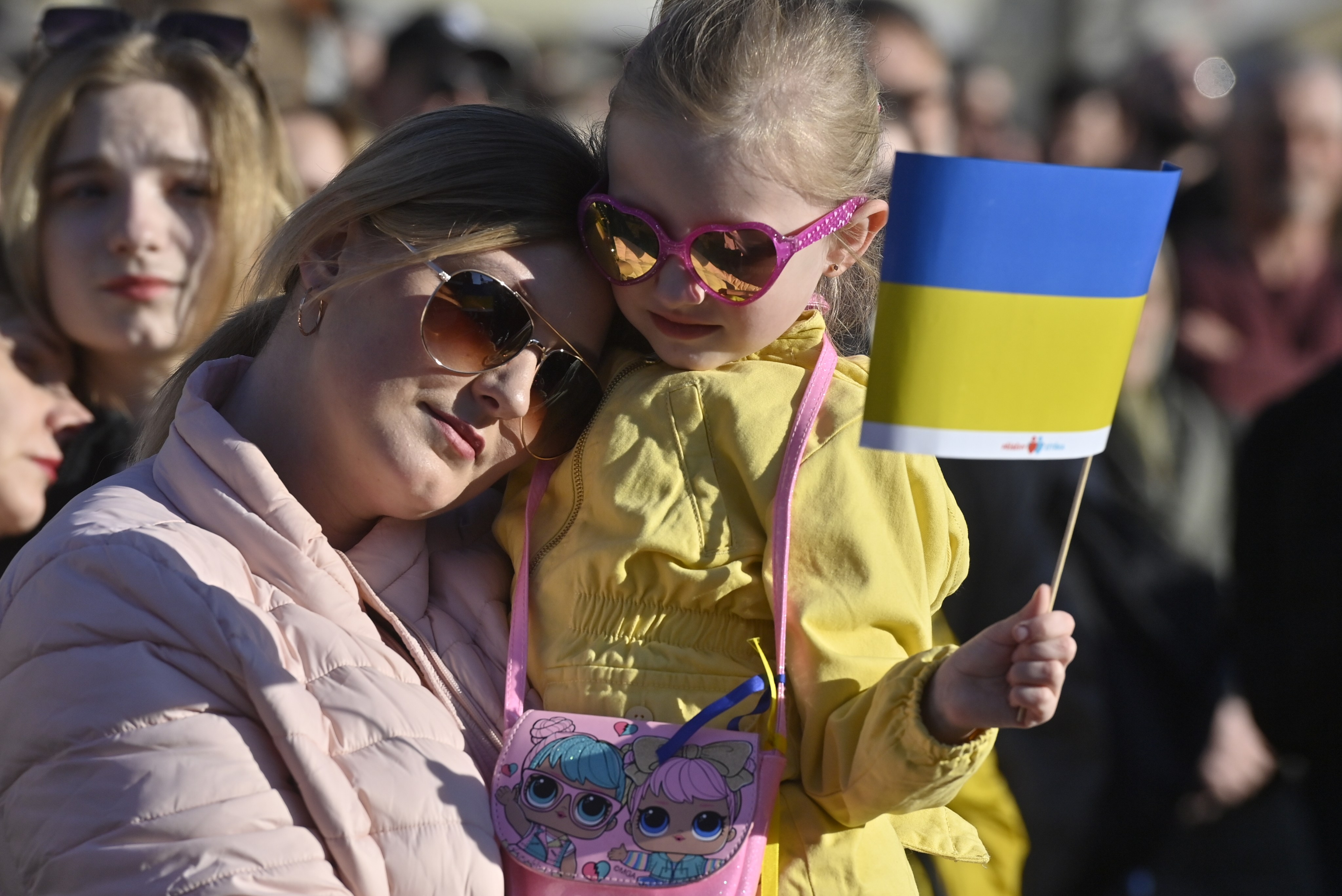 A woman and her daughter watch the streaming of benefit concert Save Ukraine – #StopWar at Prague’s Old Town Square in Czech Republic. Photo: CTK / DPA