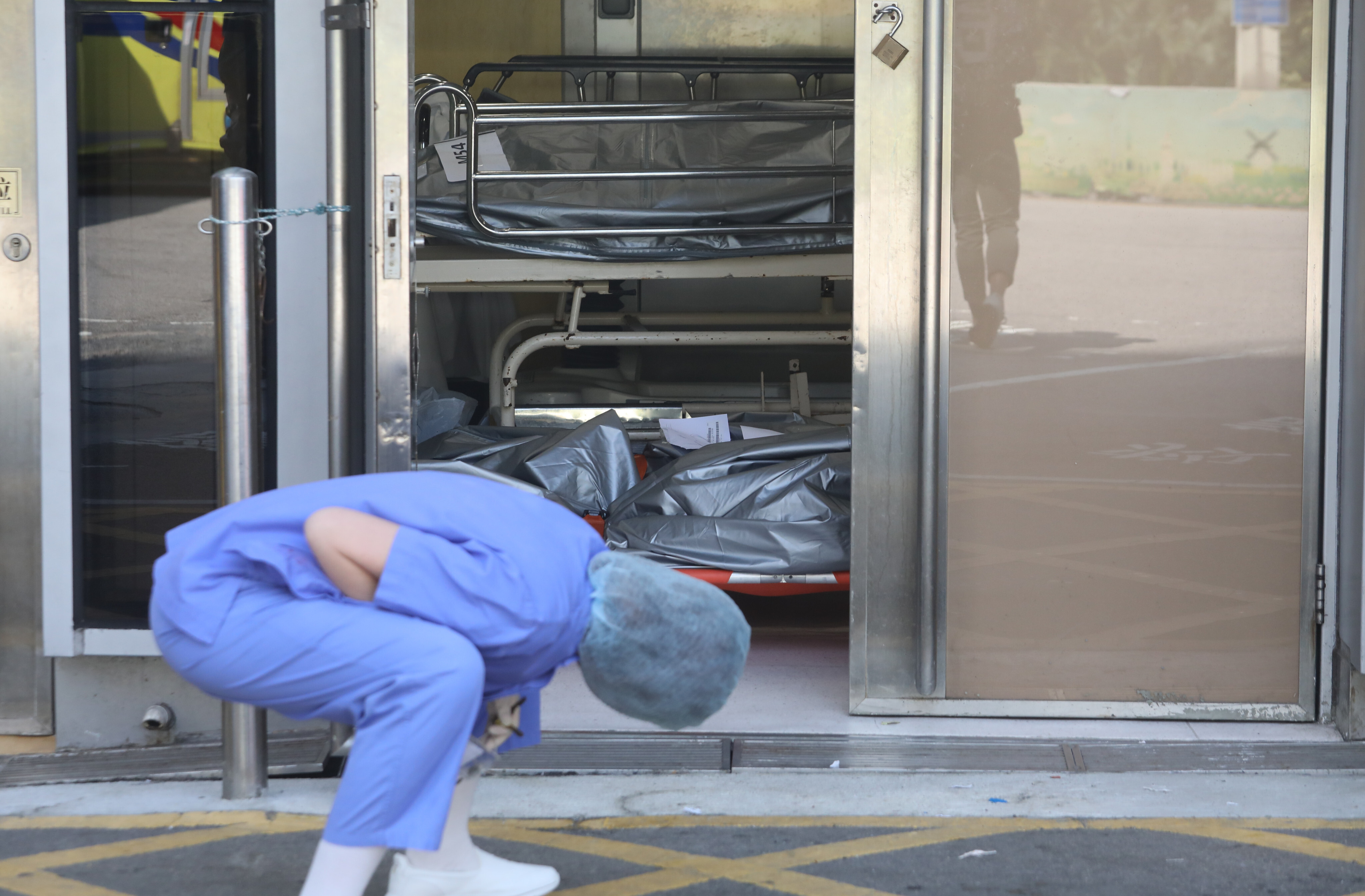 A nurse inspects bodies at Queen Elizabeth Hospital earlier this month. Photo: Jelly Tse