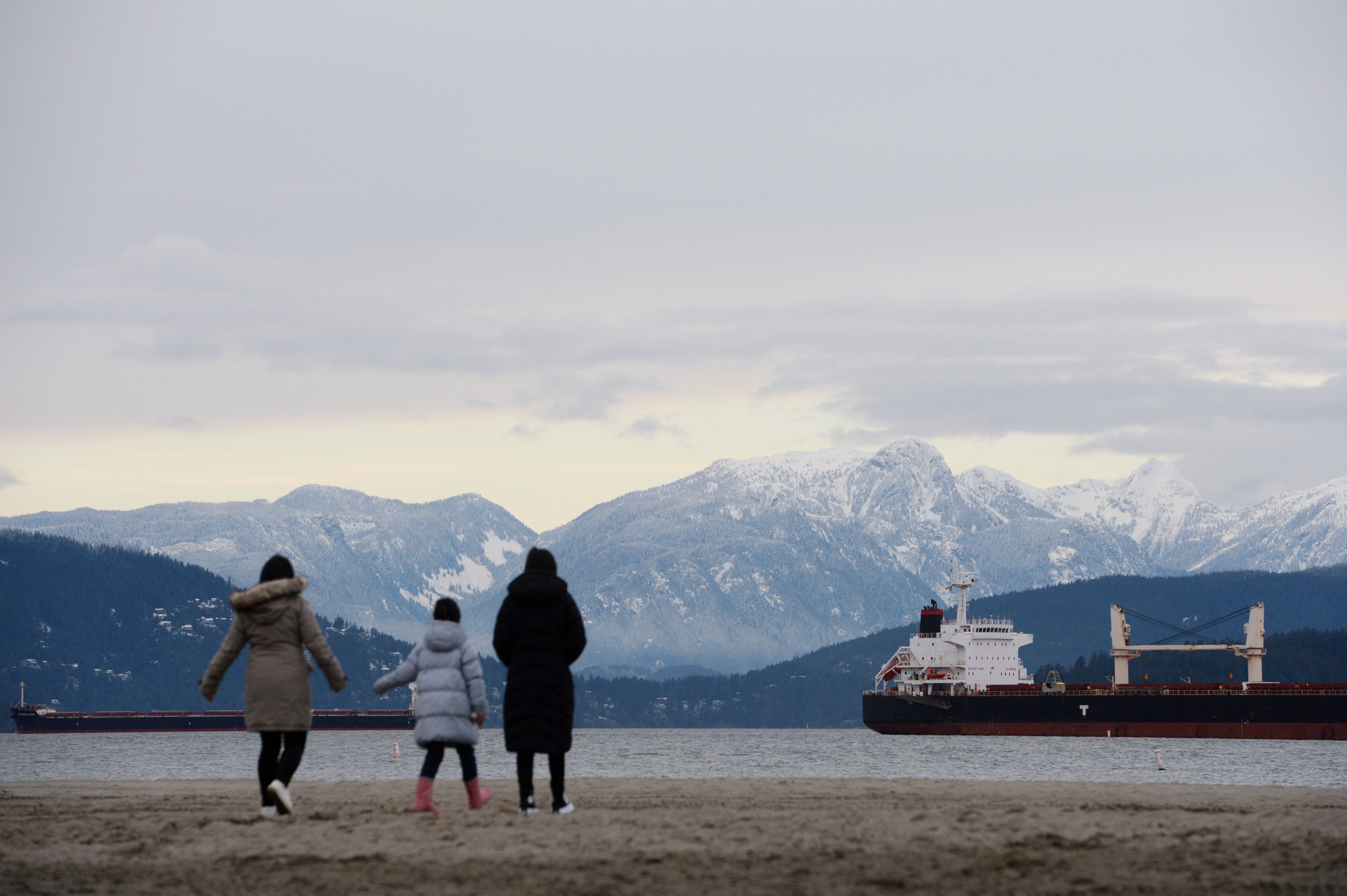 A family of new Hong Kong immigrants walk along  Jericho Beach in Vancouver, Canada in January 2021. Photo: Reuters