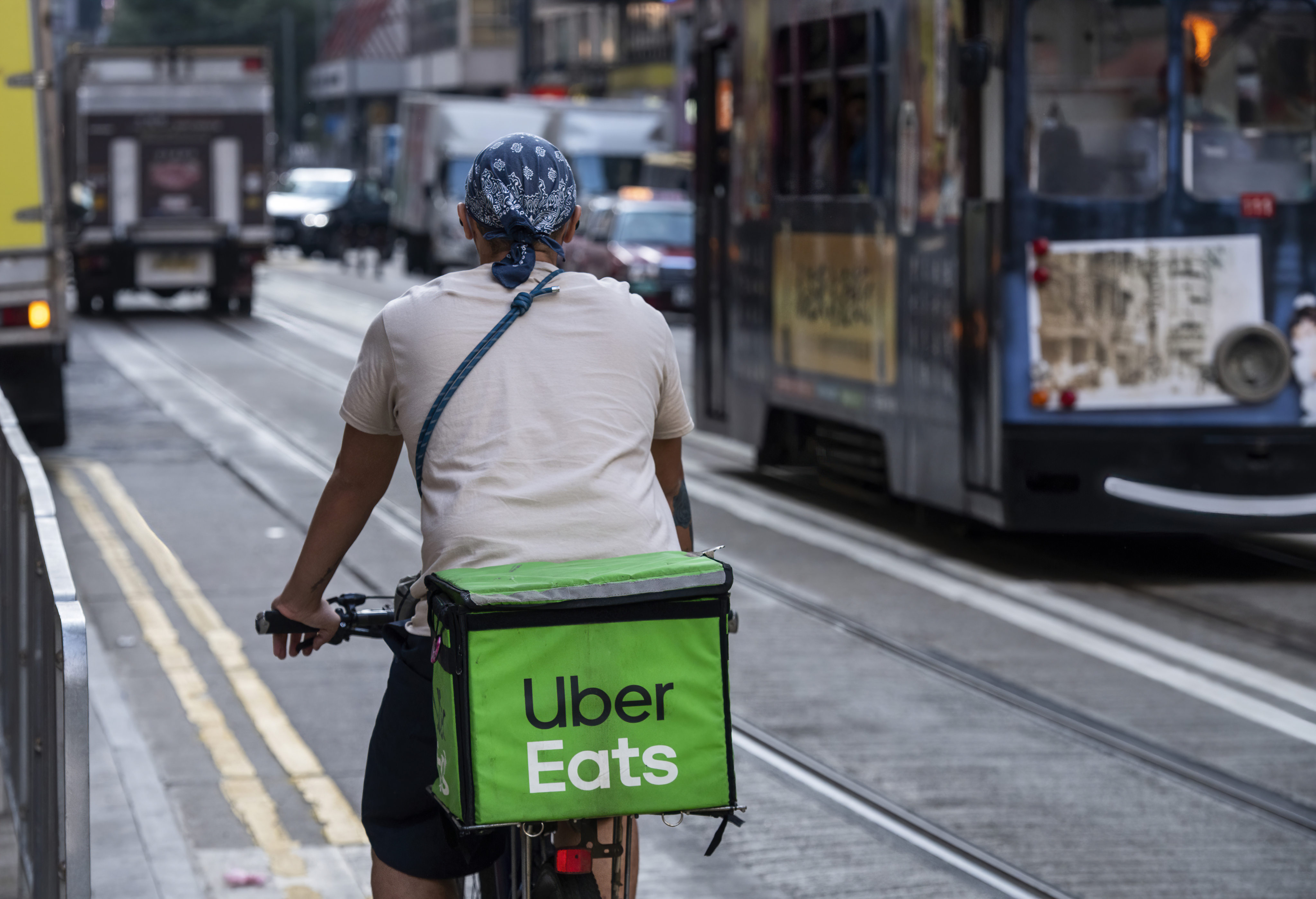 A delivery worker from Uber Eats, the ride-hailing giant’s take-out arm, is seen riding on a bicycle in Hong Kong on December 30, 2021. Photo: Anadolu Agency via Getty Images