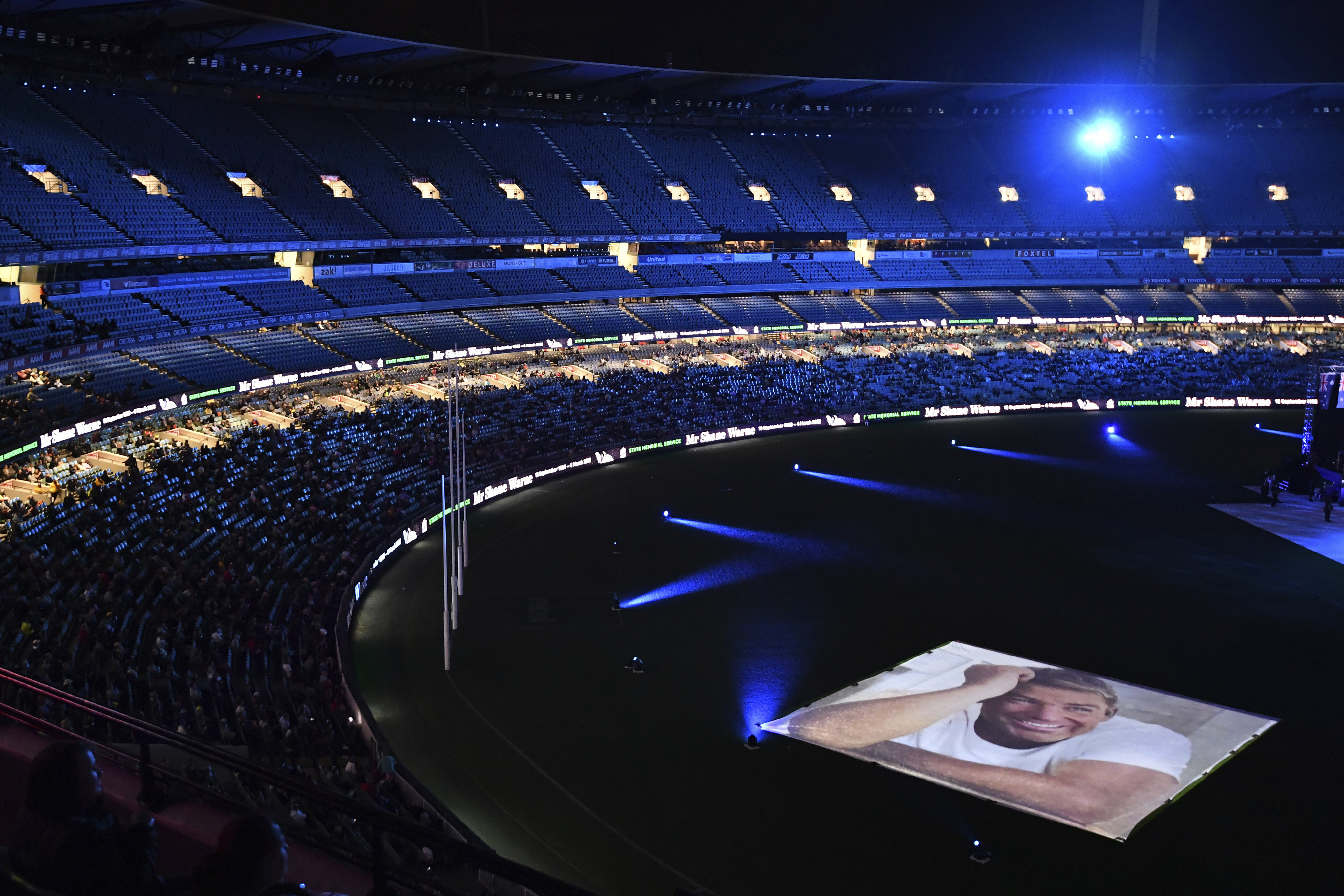 Images are projected on the ground during a memorial service for Shane Warne at the Melbourne Cricket Ground in Melbourne, Australia, on Wednesday. Warne, widely regarded as one of the top cricket players of all time, died on March 4 while on vacation with friends in Thailand. Photo: AAP Image via AP