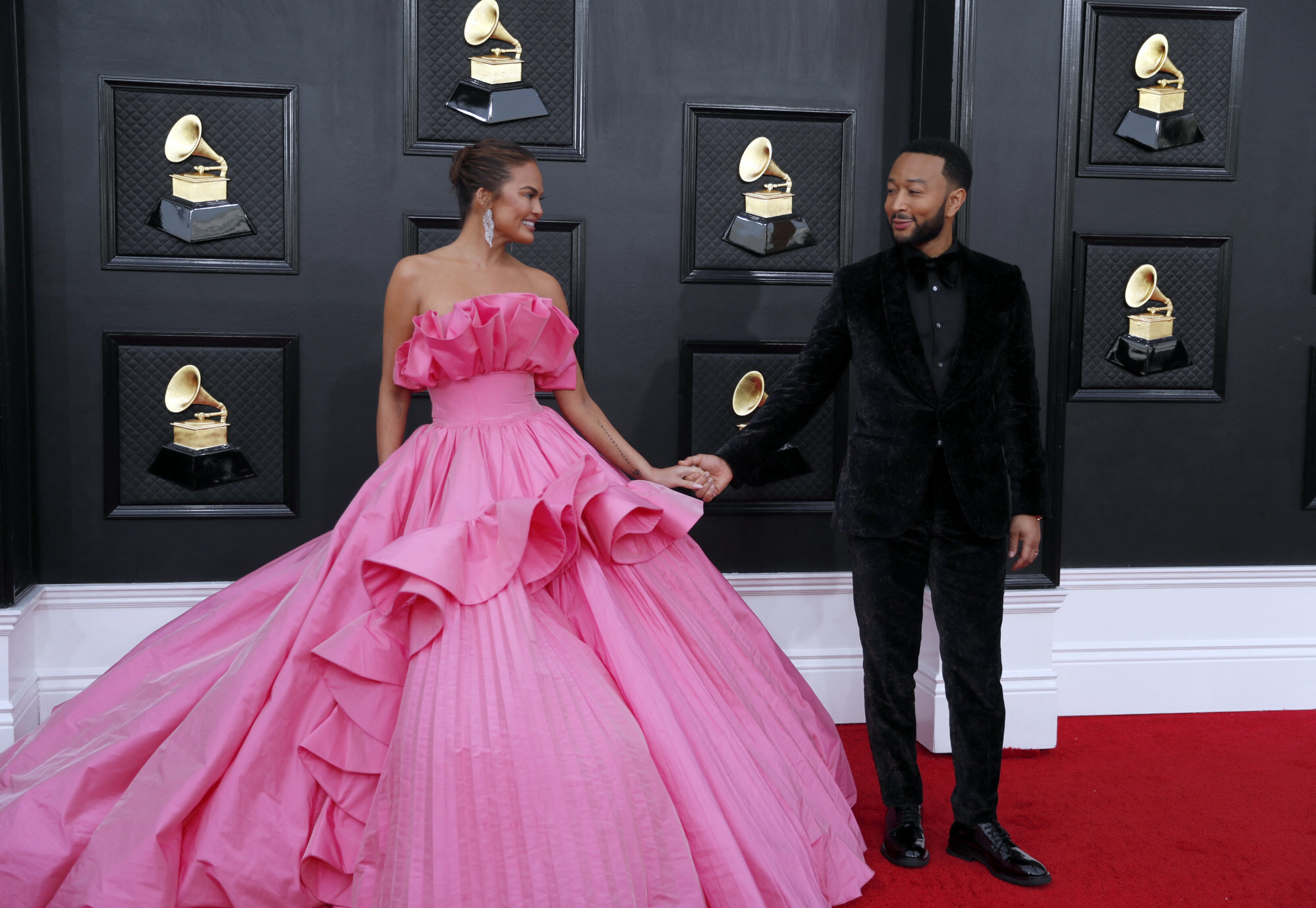 Chrissy Teigen and John Legend shared a look that said “we nailed it” when they appeared on the red carpet at this year’s Grammy Awards. Photo: Reuters