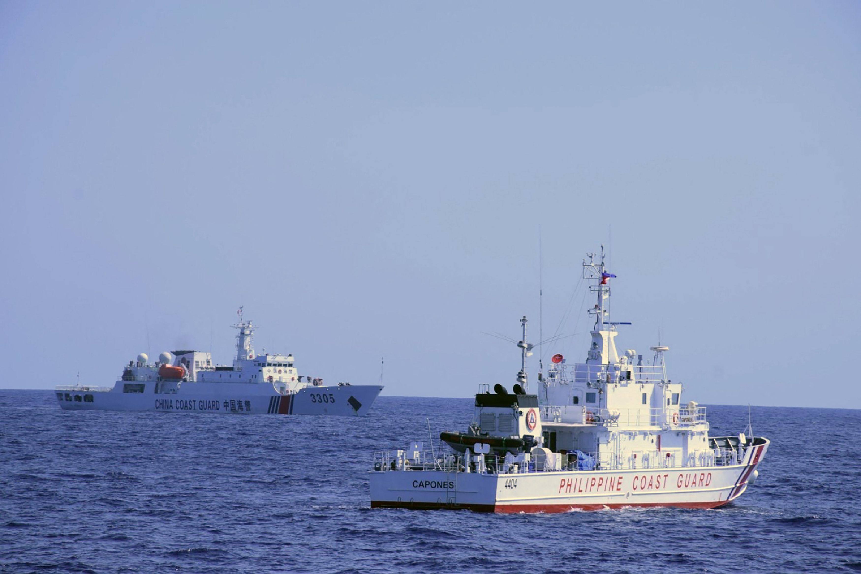 A Chinese ship shadows a Philippine coastguard vessel conducting a patrol near Scarborough Shoal. Photo: Philippine Coast Guard Handout via AFP