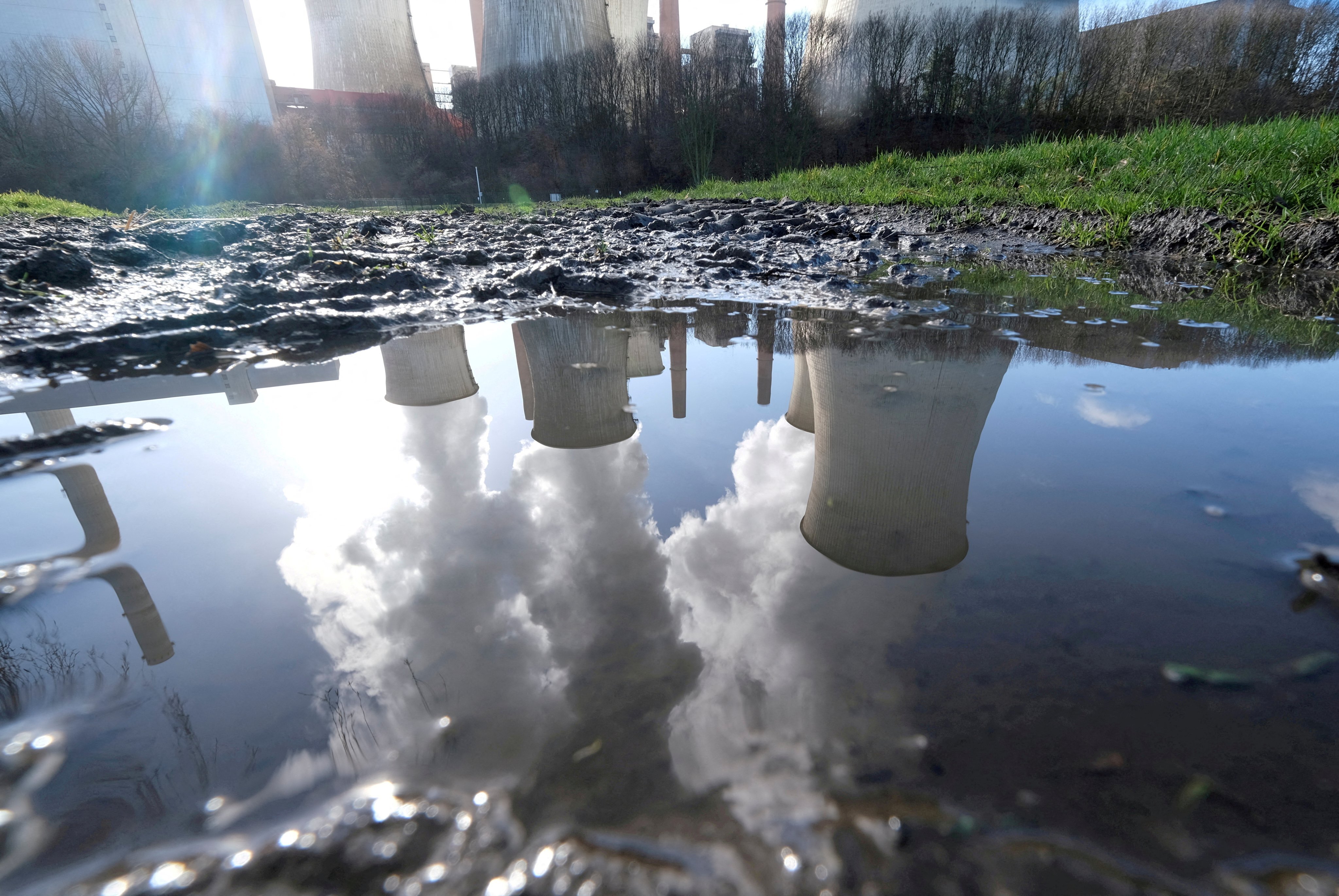 The lignite power plant complex of German energy supplier RWE is reflected in a large puddle in Neurath, northwest of Cologne, Germany, in 2020. Companies are hiring consultants to measure their carbon emissions as regulators require greater disclosures of climate risks. Photo: Reuters 