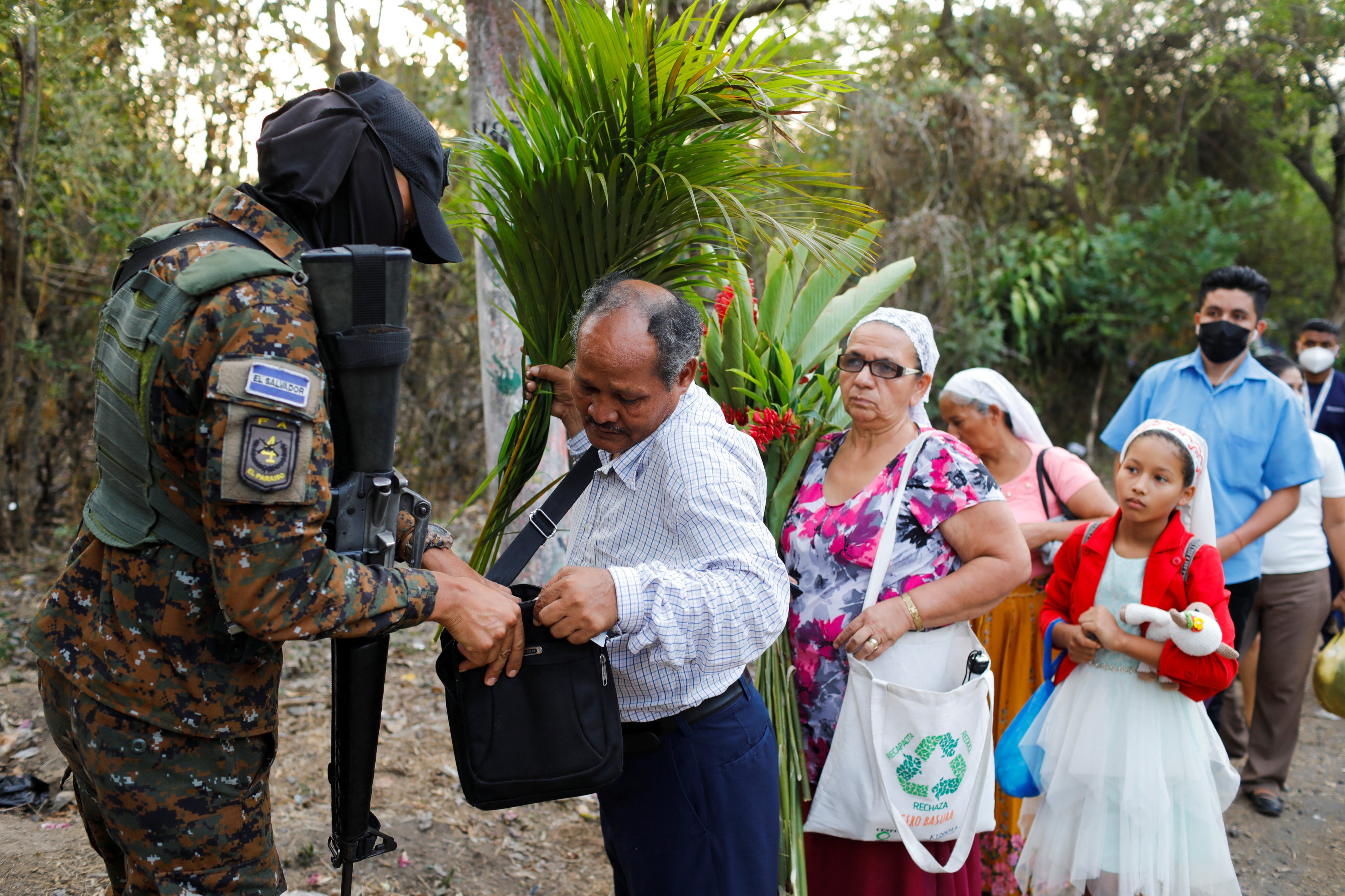 A soldier searches people at a checkpoint on Monday after El Salvador’s Congress approved emergency powers that temporarily suspended some constitutional protections. Photo: Reuters