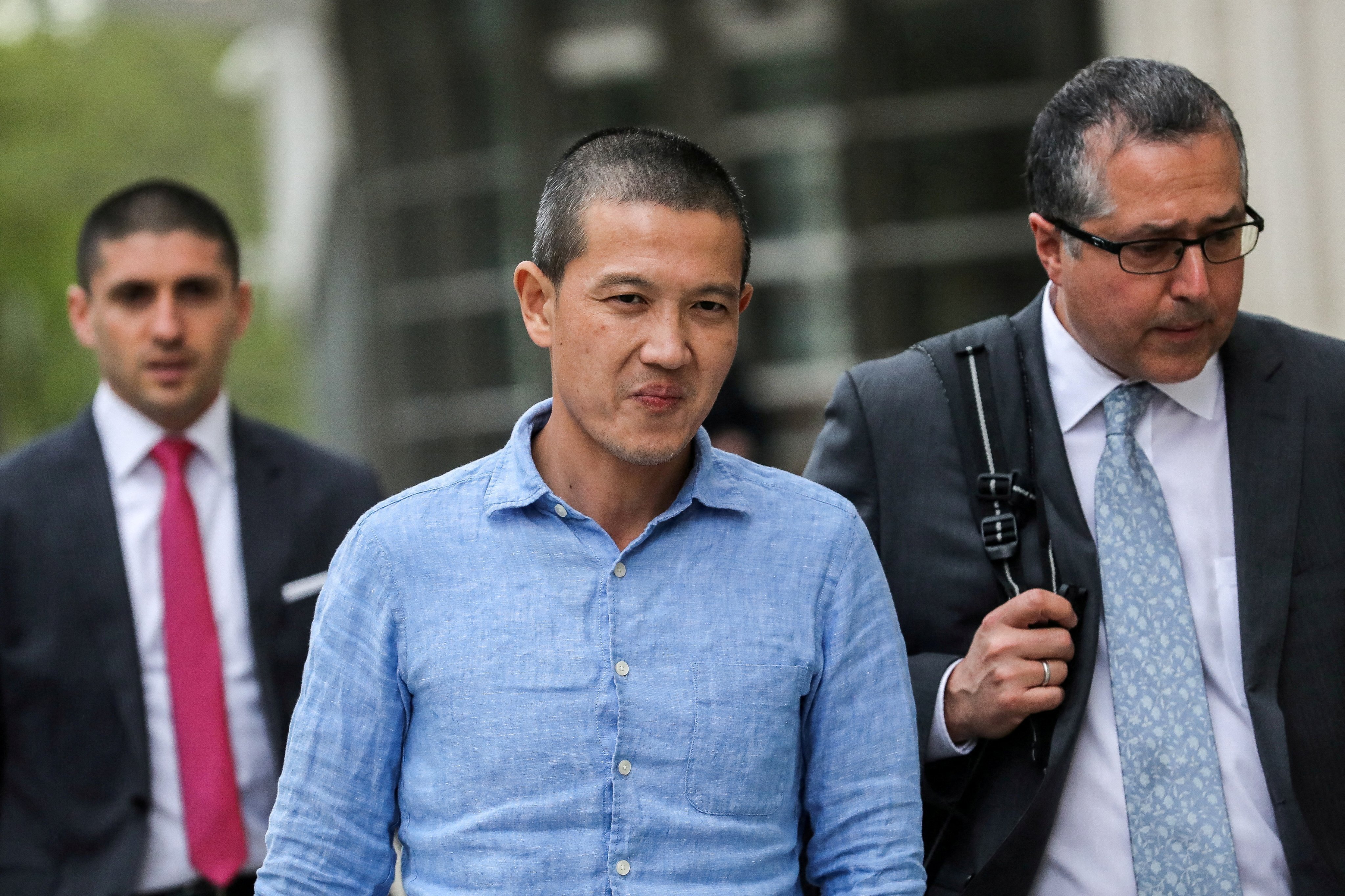 Ex-Goldman Sachs banker Roger Ng (centre) and his lawyer Marc Agnifilo (right) leave federal court in New York in May 2019. Photo: Reuters