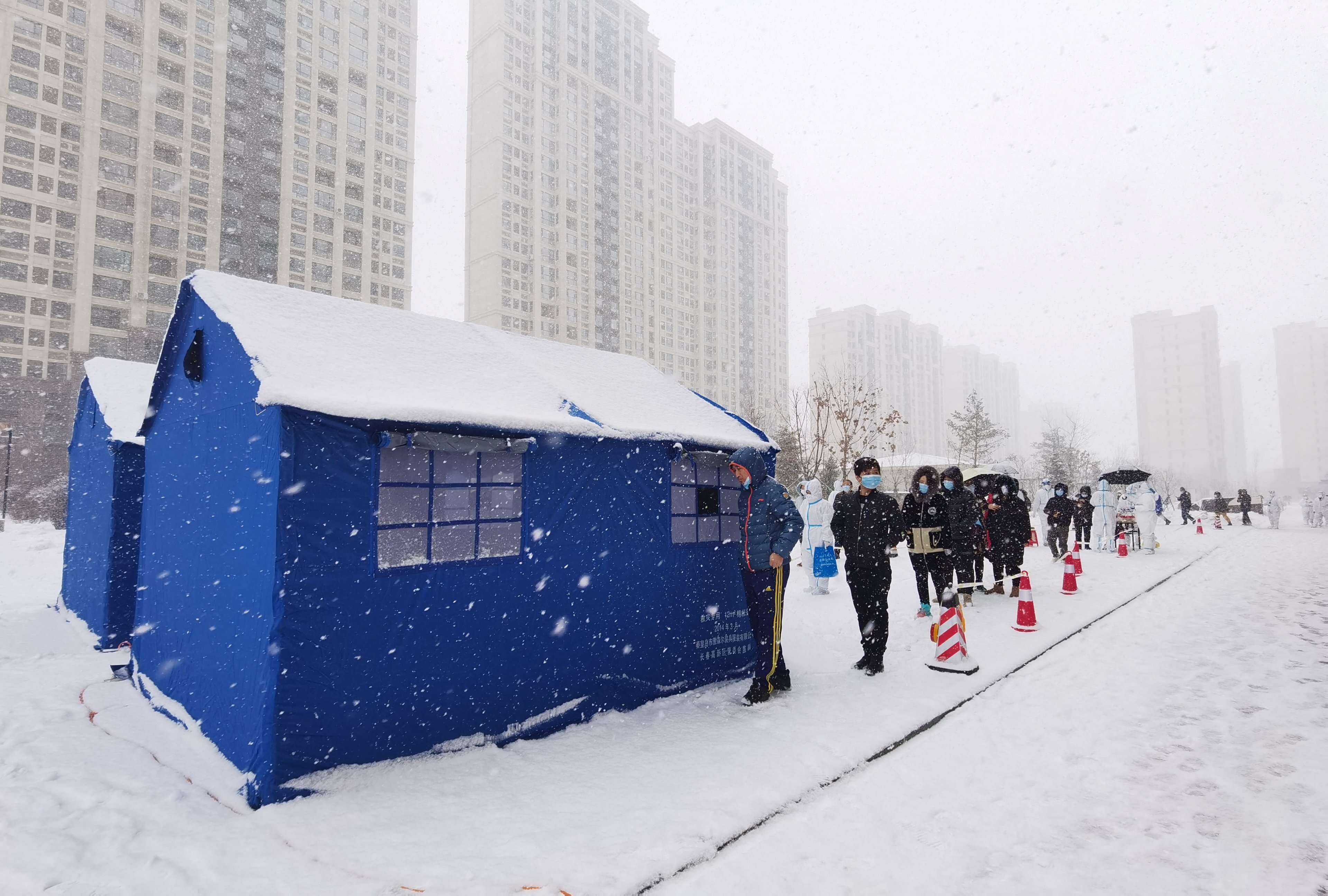 Residents of Changchun, Jilin province, line up for coronavirus testing. Authorities in the provincial capital will distribute cash and medical supplies to more than 50,000 people. Photo: Reuters