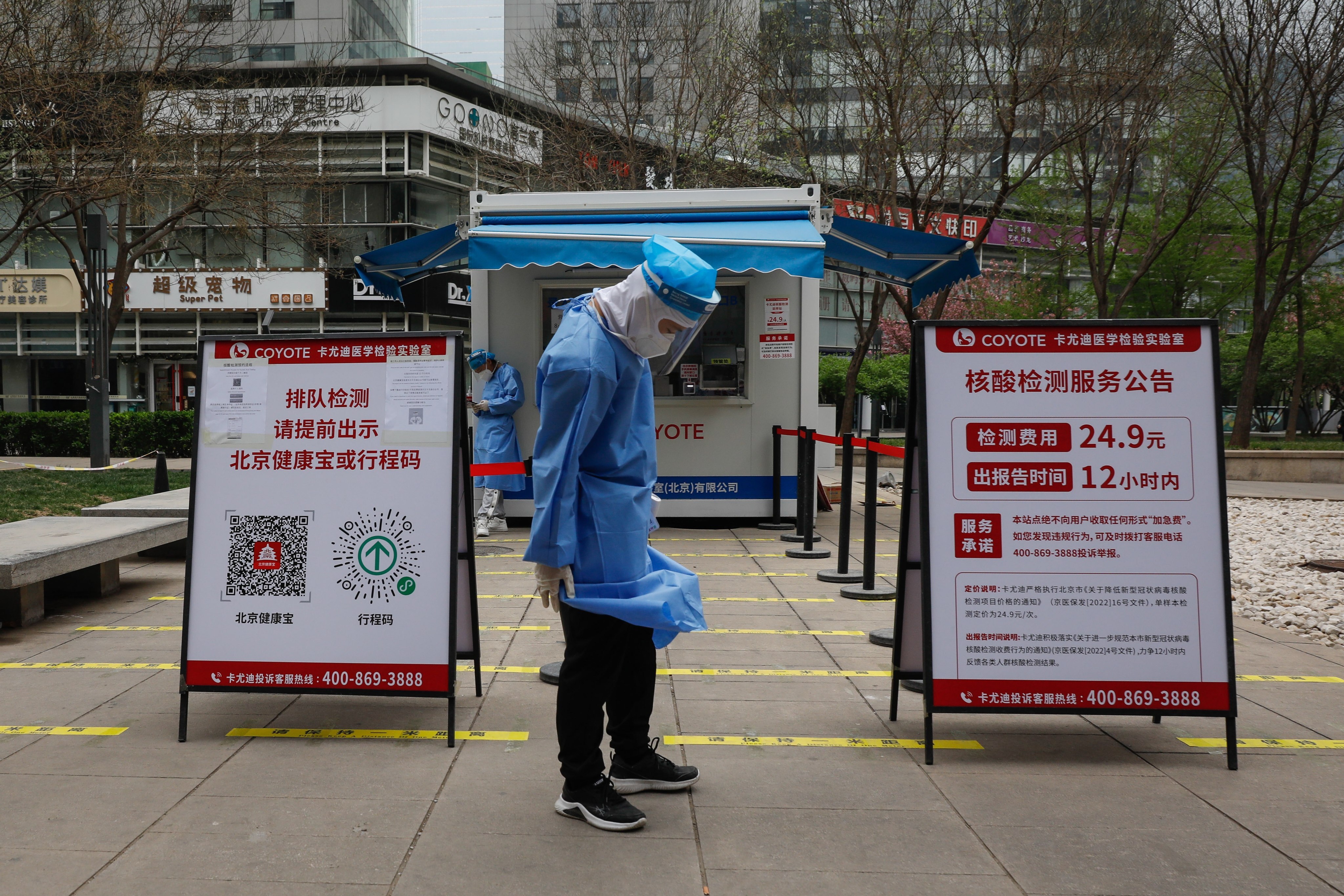 Health workers wait for people at a coronavirus testing site in Beijing on Monday. Photo: EPA-EFE