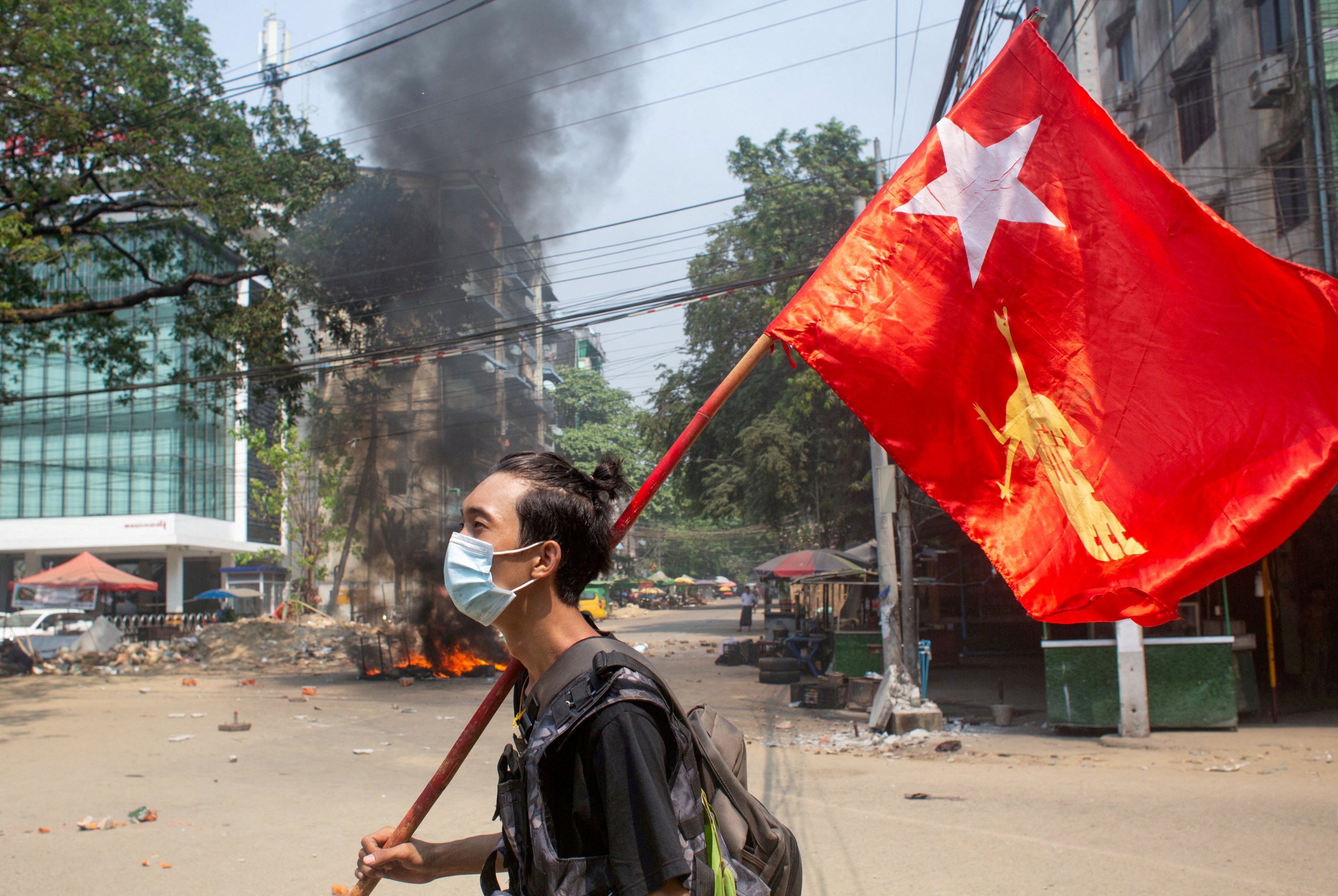 A man holds a National League for Democracy (NLD) flag during a protest against the military coup in Yangon. File photo: Reuters