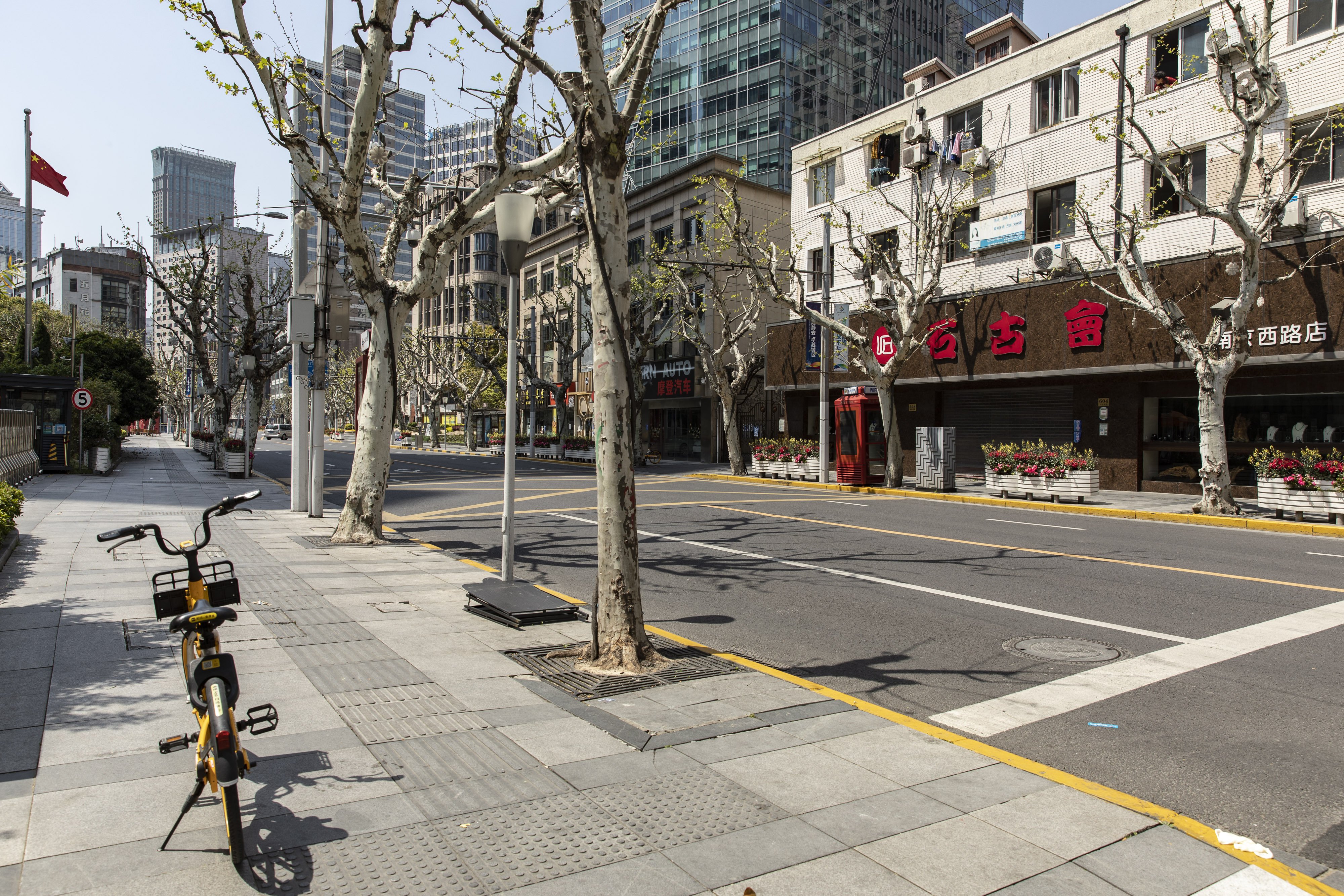 A deserted street in Shanghai on April 9. The Shanghai government has announced tweaks to its lockdown policy, yet overall measures remained stringent as residents living in communities with Covid-19 cases in the past seven days are barred from leaving their homes. Photo: Bloomberg