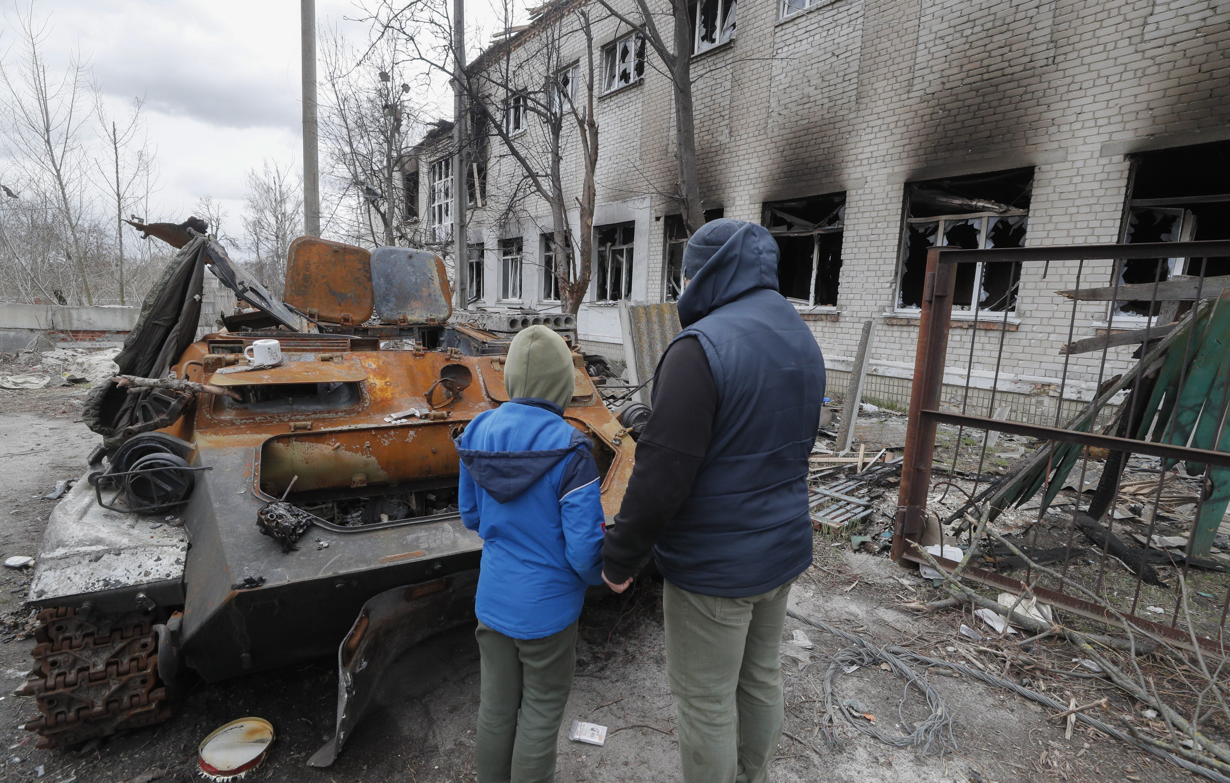  A man with his son examine a damaged school near Brovary, in Kyiv.
Photo: EPA-EFE