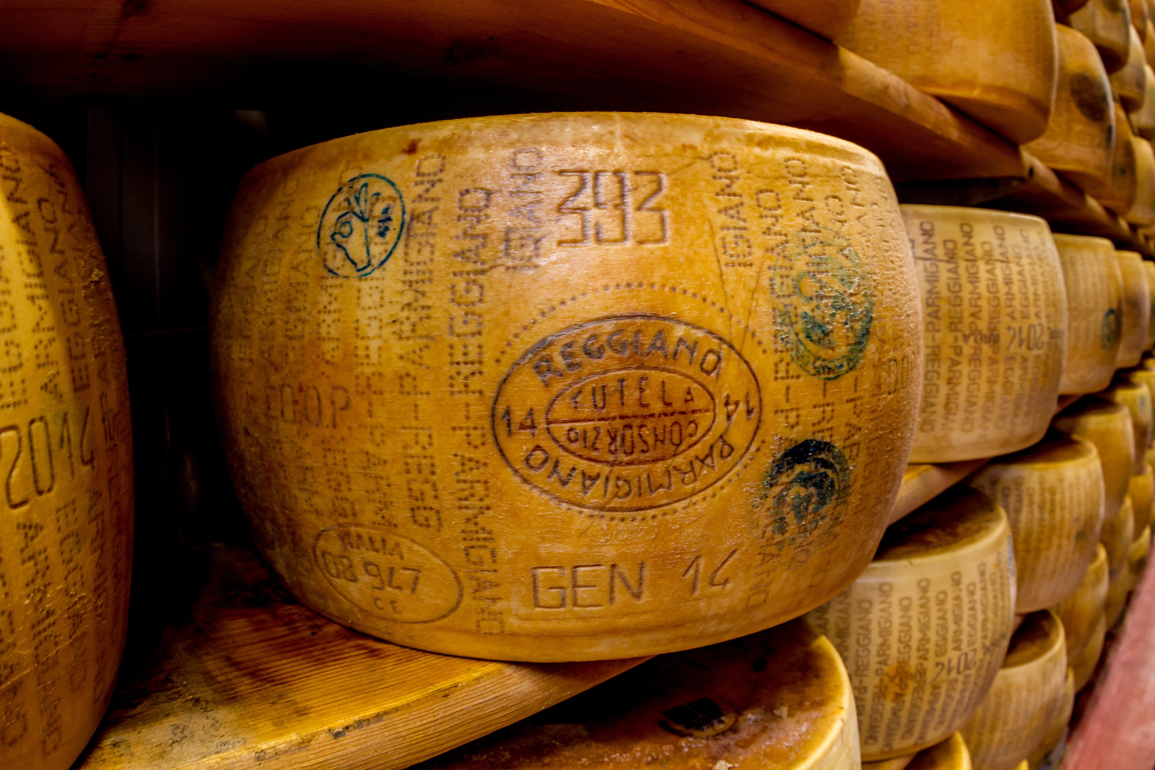 Parmesan cheese wheels stored for ageing. Photo: Getty Images