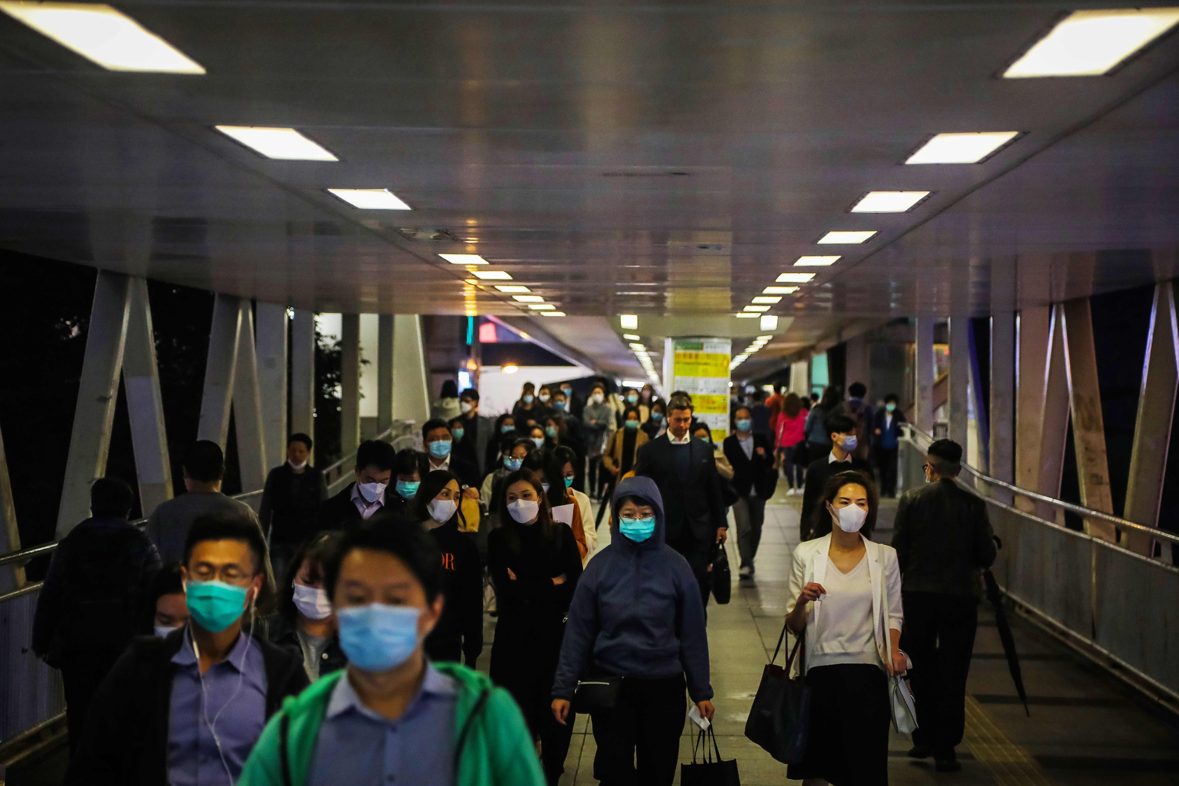 People wear face masks amid concerns about the spread of the Covid-19 coronavirus during the evening rush hour in Hong Kong at the start of the pandemic. Photo: AFP