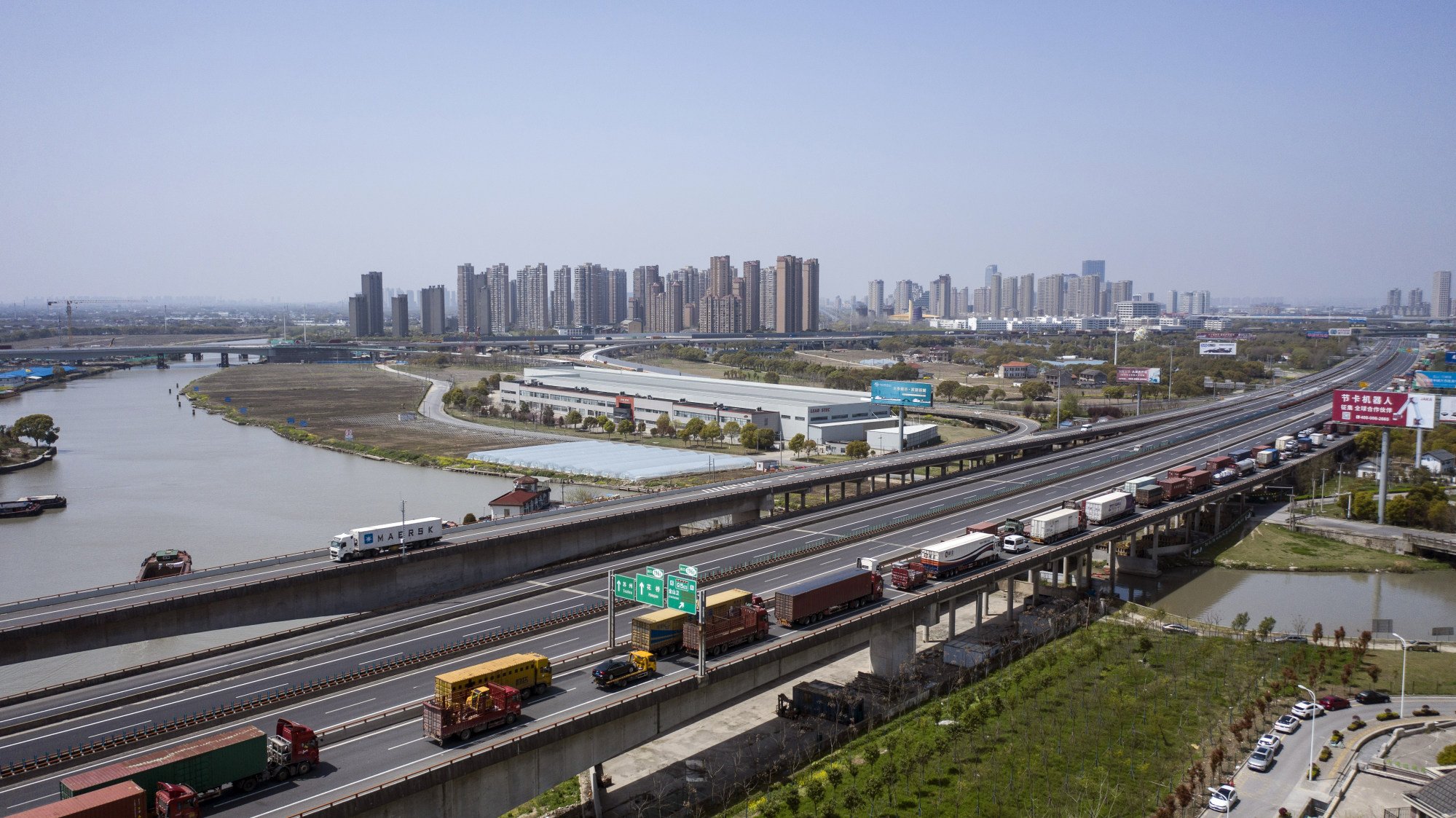 Trucks wait to pass through a checkpoint on a highway leading out of Shanghai. Photo: Bloomberg