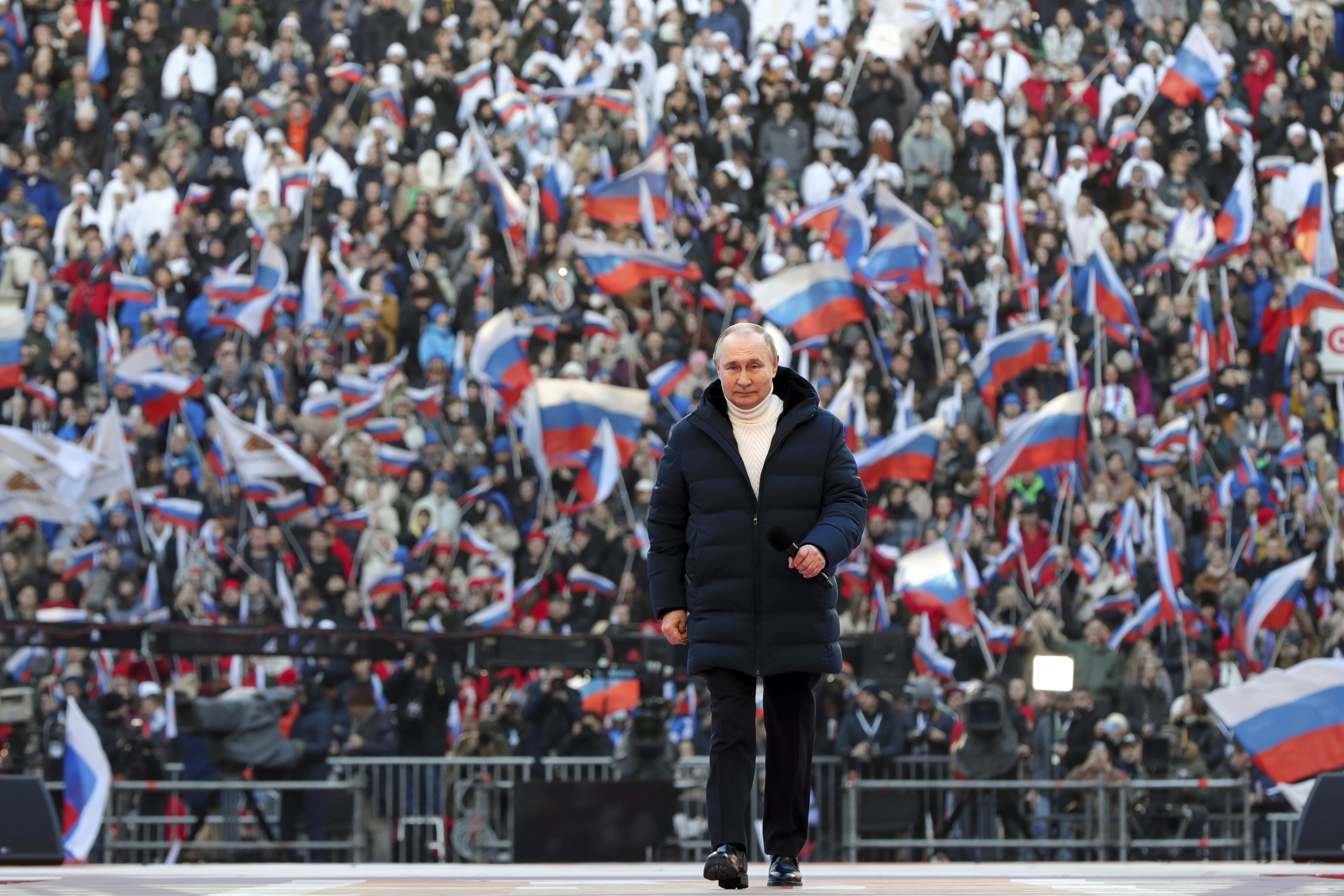 Russian President Vladimir Putin arrives to deliver his speech at the concert marking the eighth anniversary of the referendum on the state status of Crimea and Sevastopol and its reunification with Russia, in Moscow on March 18. Photo: Sputnik / AP