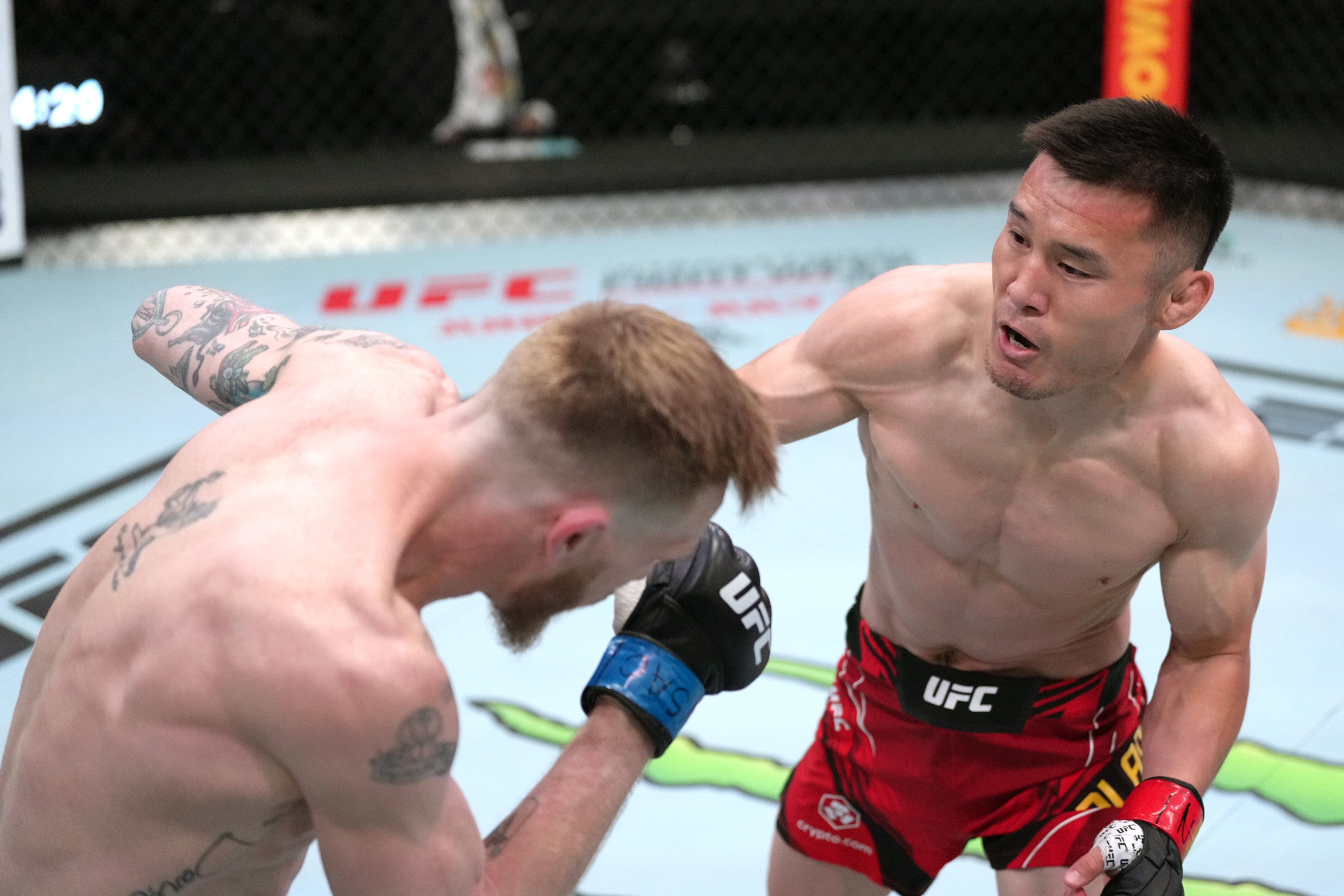 Heili Alateng of China punches Kevin Croom in a bantamweight fight at the UFC Vegas 51 event. Photo: Jeff Bottari/Zuffa LLC