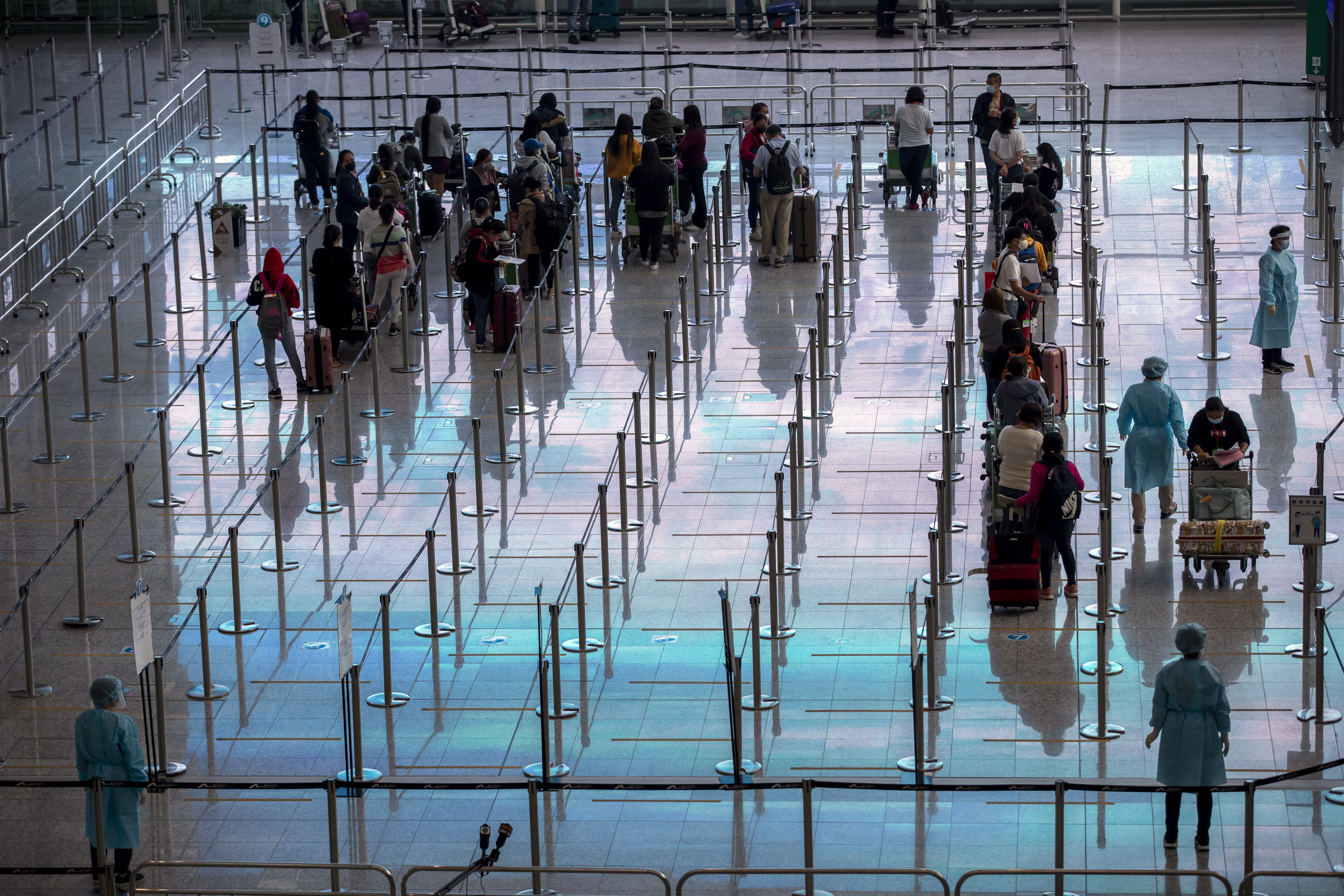 Travellers heading to quarantine in the arrival hall at Hong Kong International Airport on April 1. About 10,000 passenger flights arrived and left in the first three months of the year, an average of 111 a day. Photo: Bloomberg