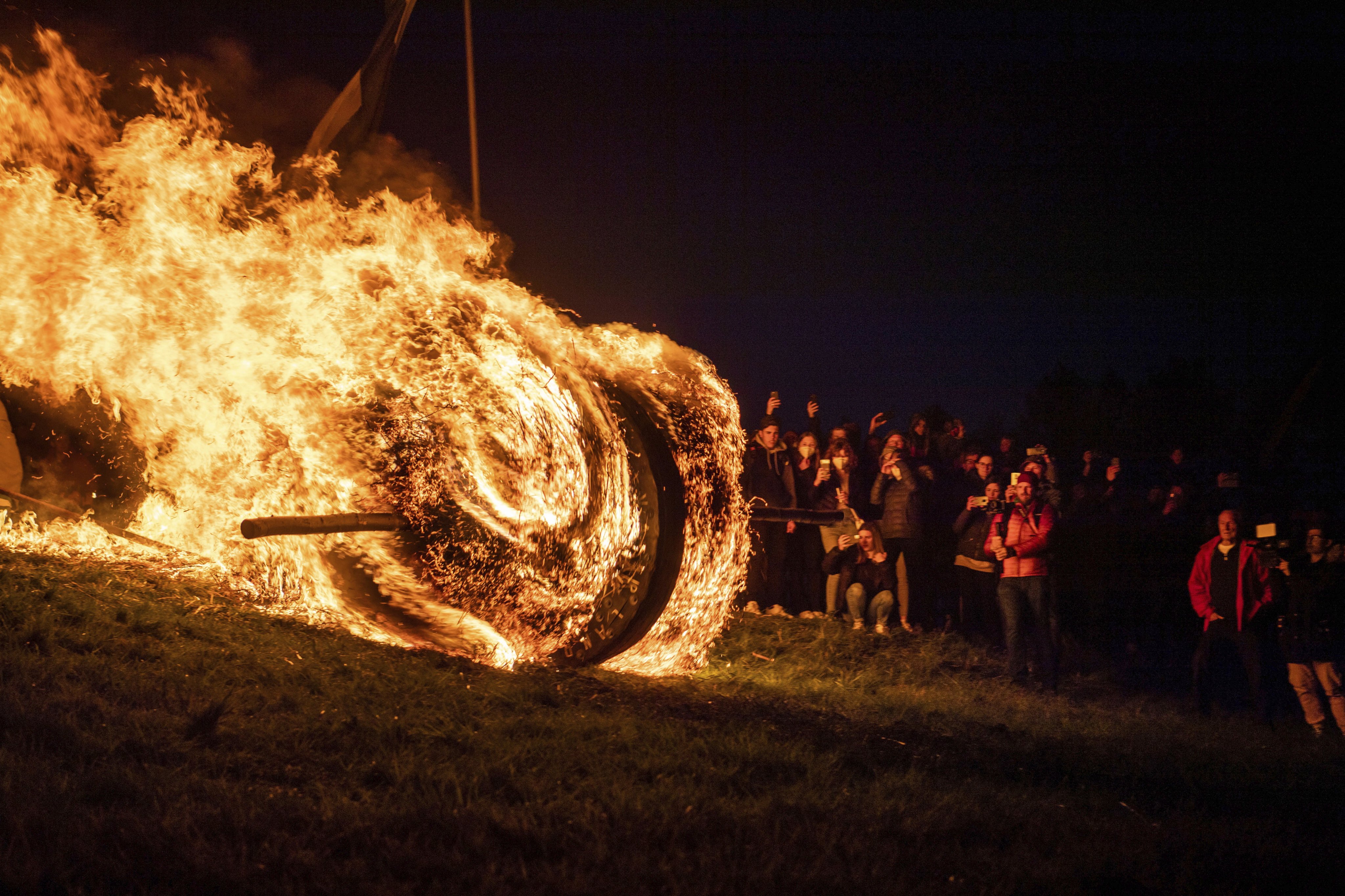 A burning Easter wheel “runs” down the hill in Lügde, North Rhine-Westphalia, Germany. Photo: DPA via AP