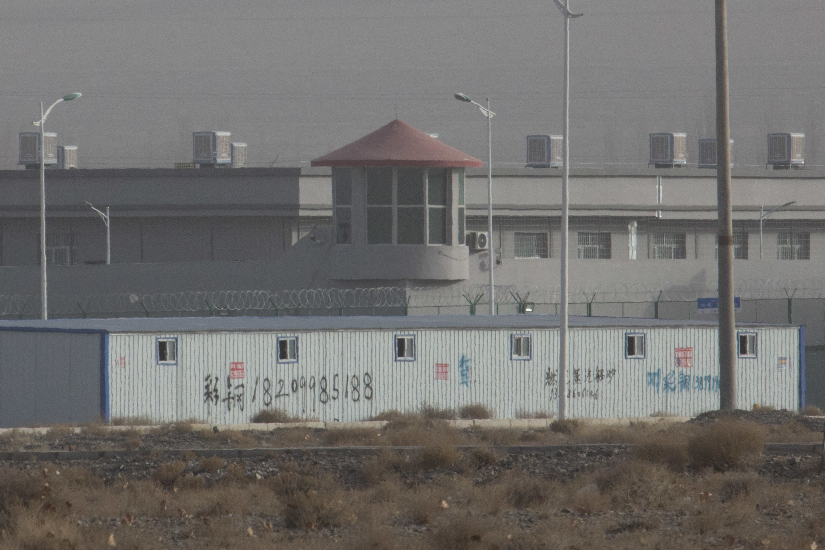 A guard tower and barbed wire fences are seen around a facility in an industrial park in  Xinjiang in 2018. Photo: AP 