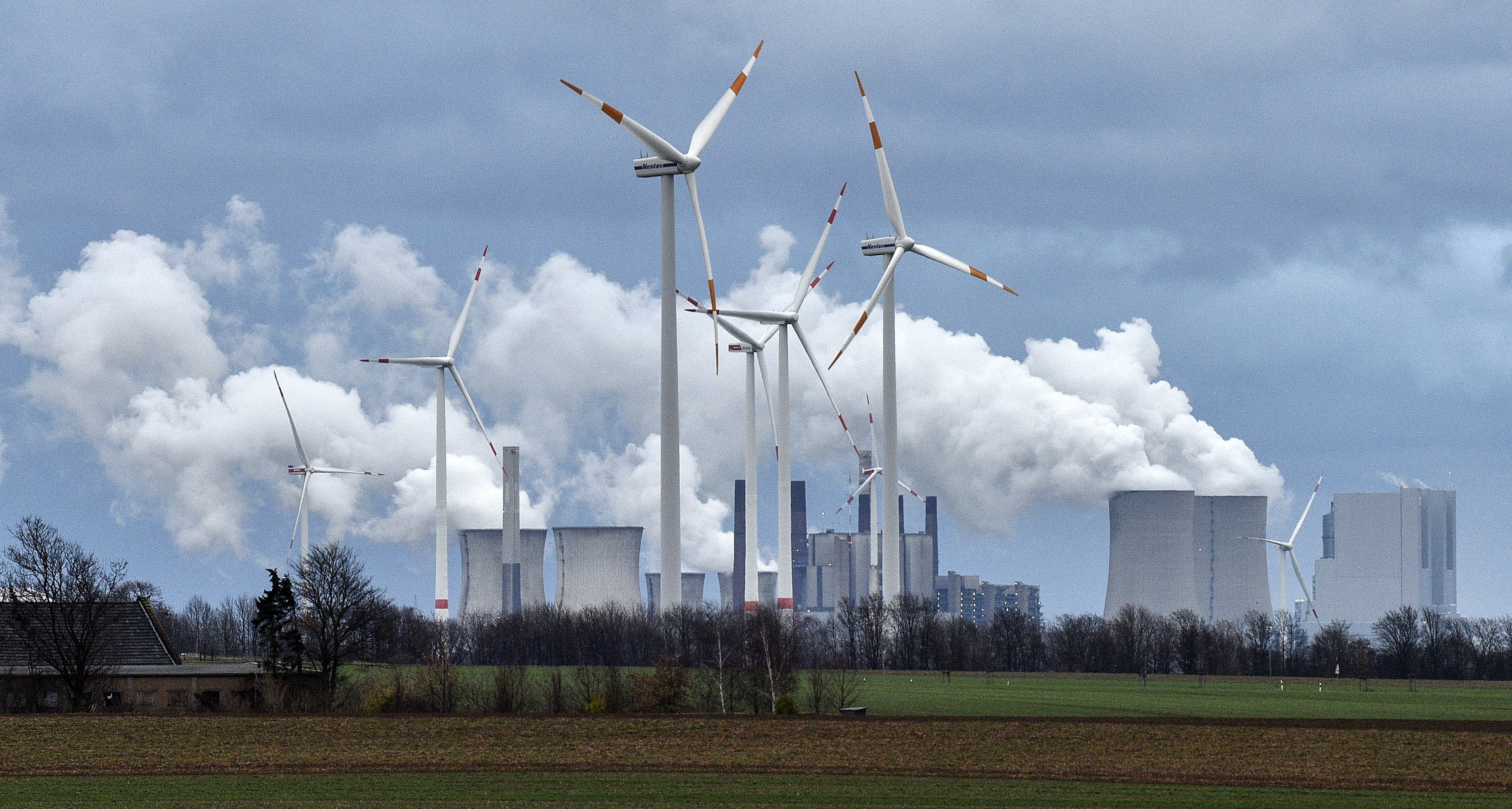 Wind turbines are seen in front of a coal-fired power plant in Germany in December 2018. The country has committed to increasing its wind power production. Photo: AP