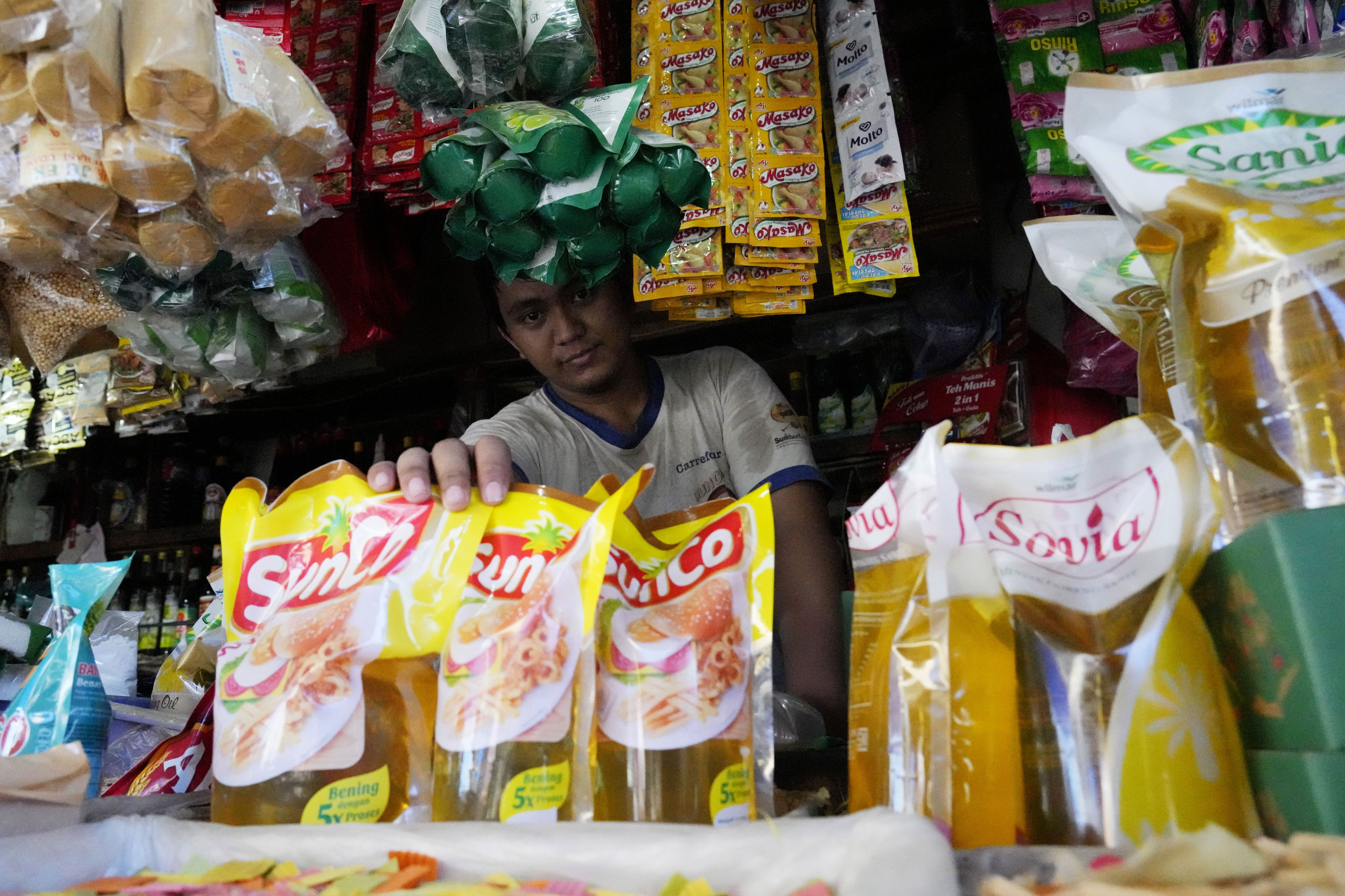 A vendor with packs of cooking oil at a market in Jakarta, Indonesia. Photo: AP 