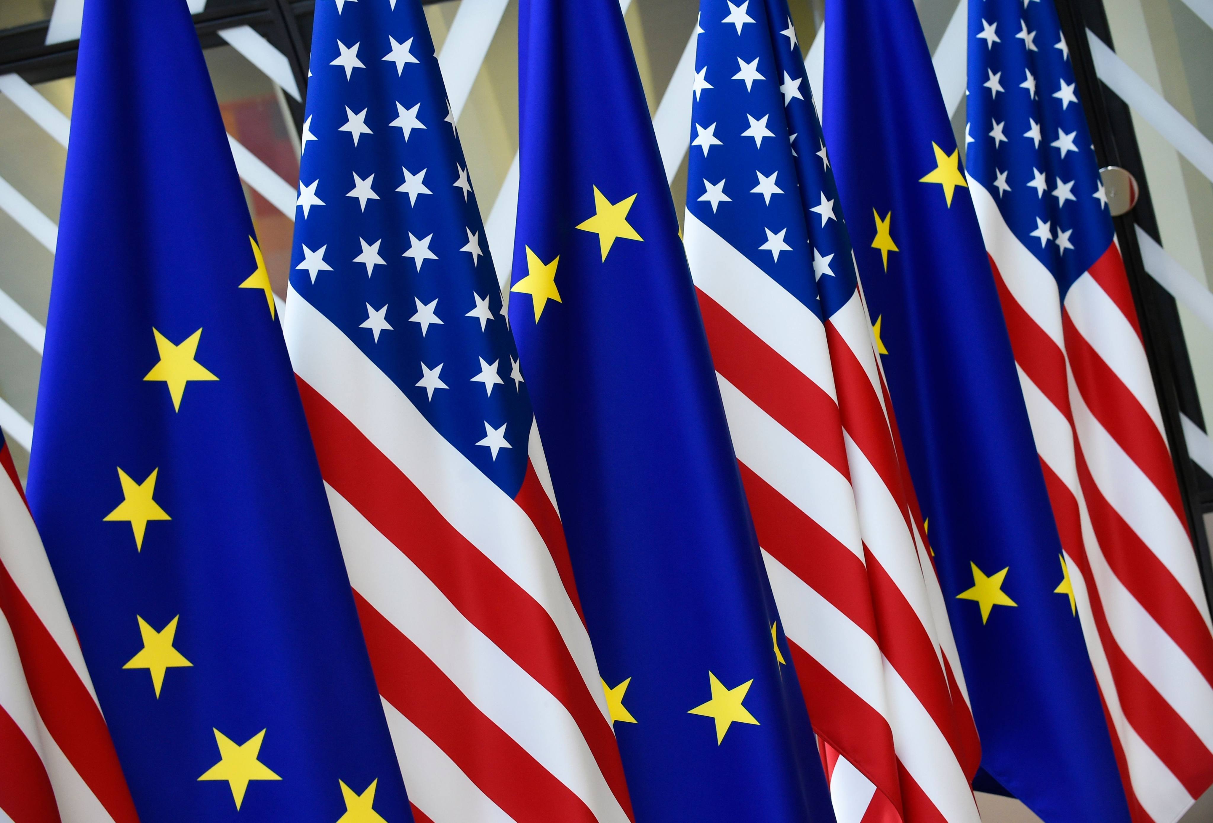 US and European Union flags are seen at the EU headquarters in Brussels. Photo: AFP