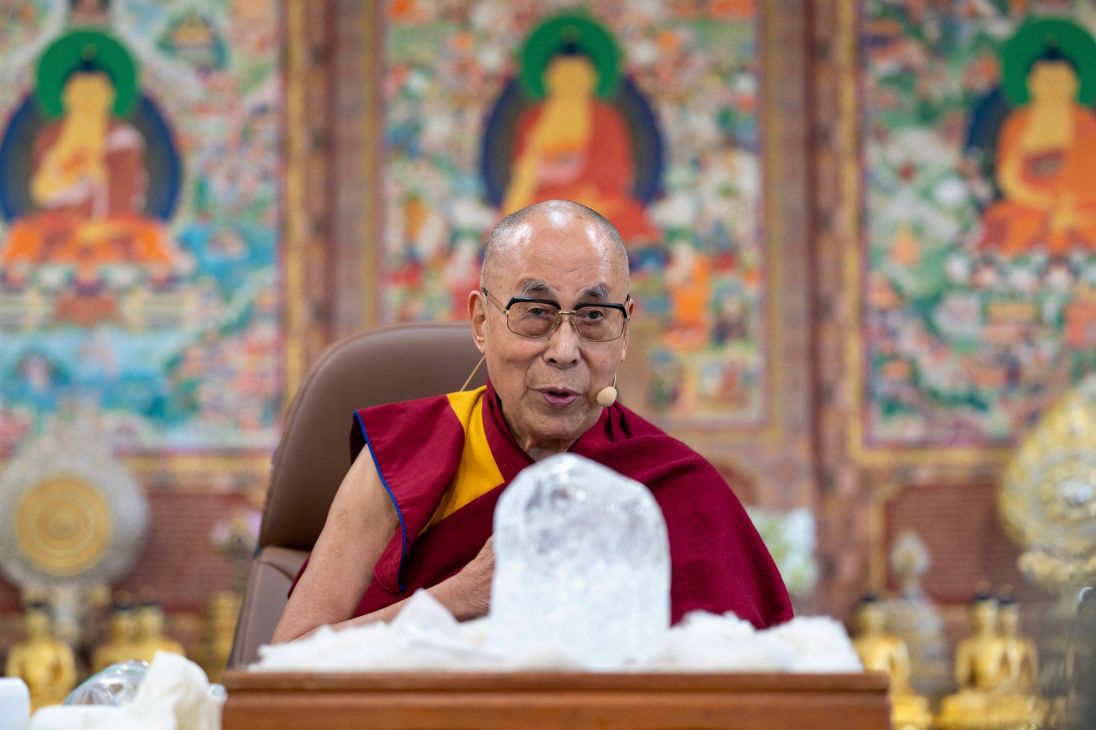 Tibetan spiritual leader the Dalai Lama with a block of ice from the Himalayas, talks about climate change. Photo: AFP
