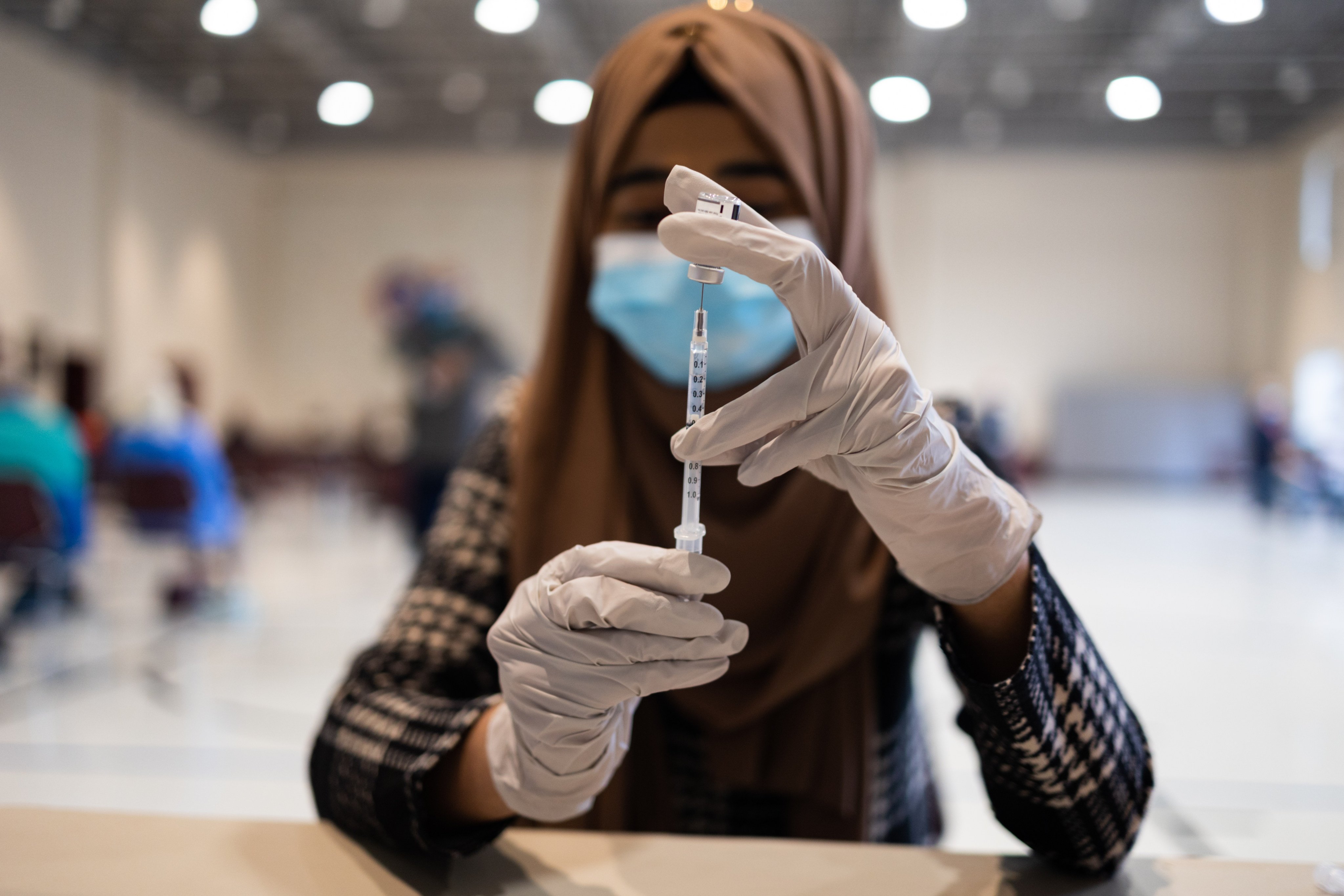 A health worker prepares a dose of the Pfizer-BioNTech Covid-19 booster shot in Lansdale, Pennsylvania. Photo: Bloomberg