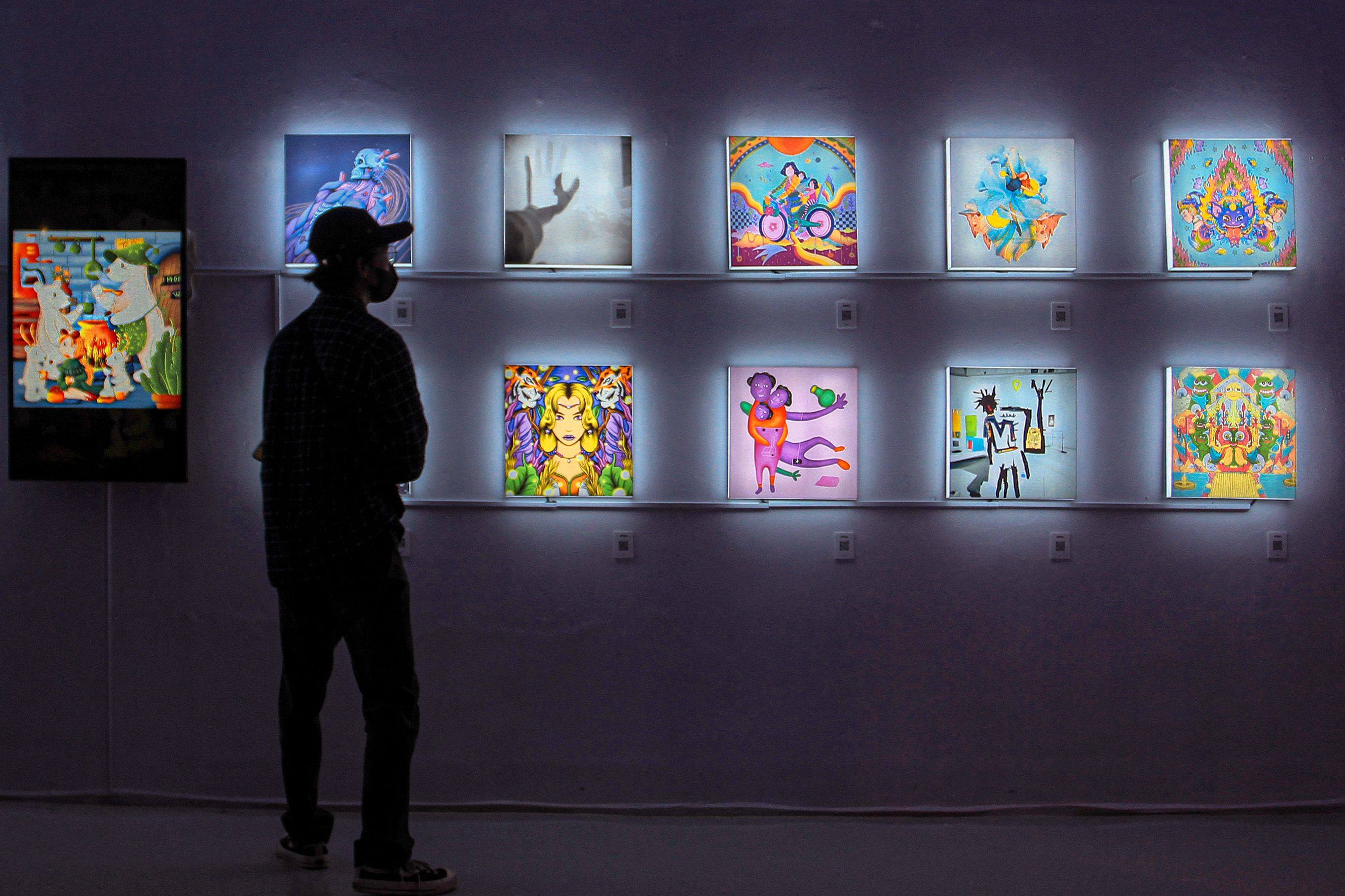 A visitor observes NFT works at an exhibition in Yogyakarta, Indonesia. A Chinese court recently ruled on a case regarding NFT art theft. Photo: AFP
