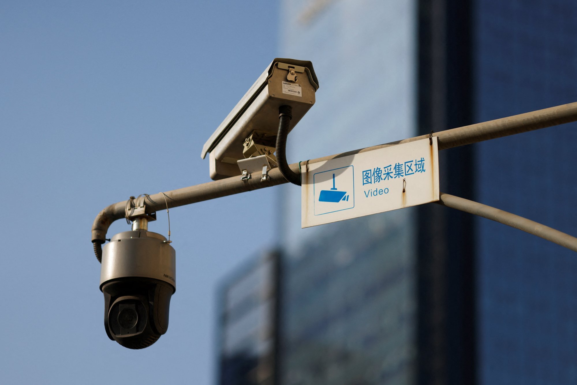 Hikvision surveillance cameras overlook a street in Beijing in December. Photo: Reuters