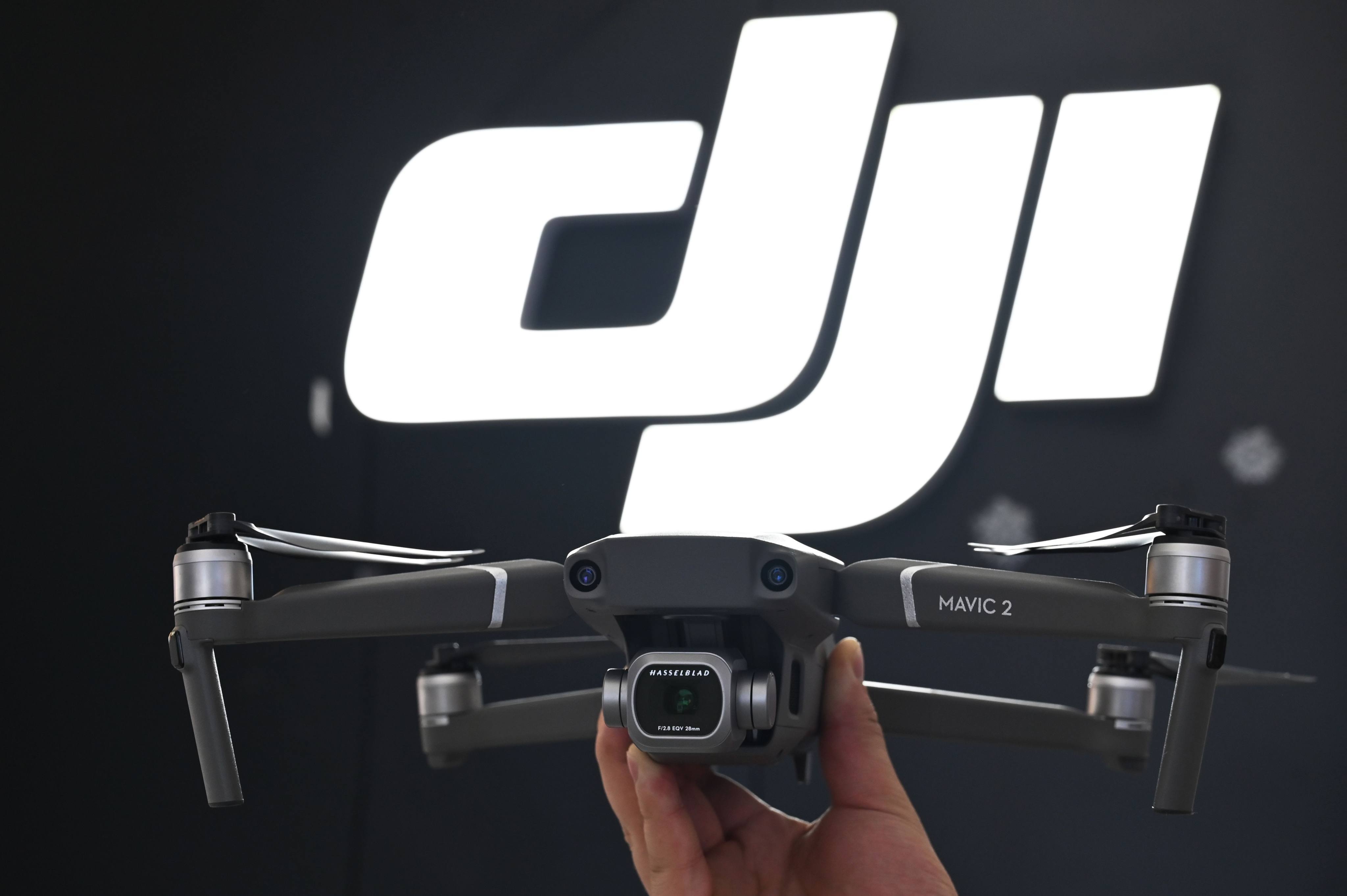 An employee shows the Mavic Pro 2 drone in a DJI store in Shanghai on May 22, 2019. Photo: Agence France-Presse