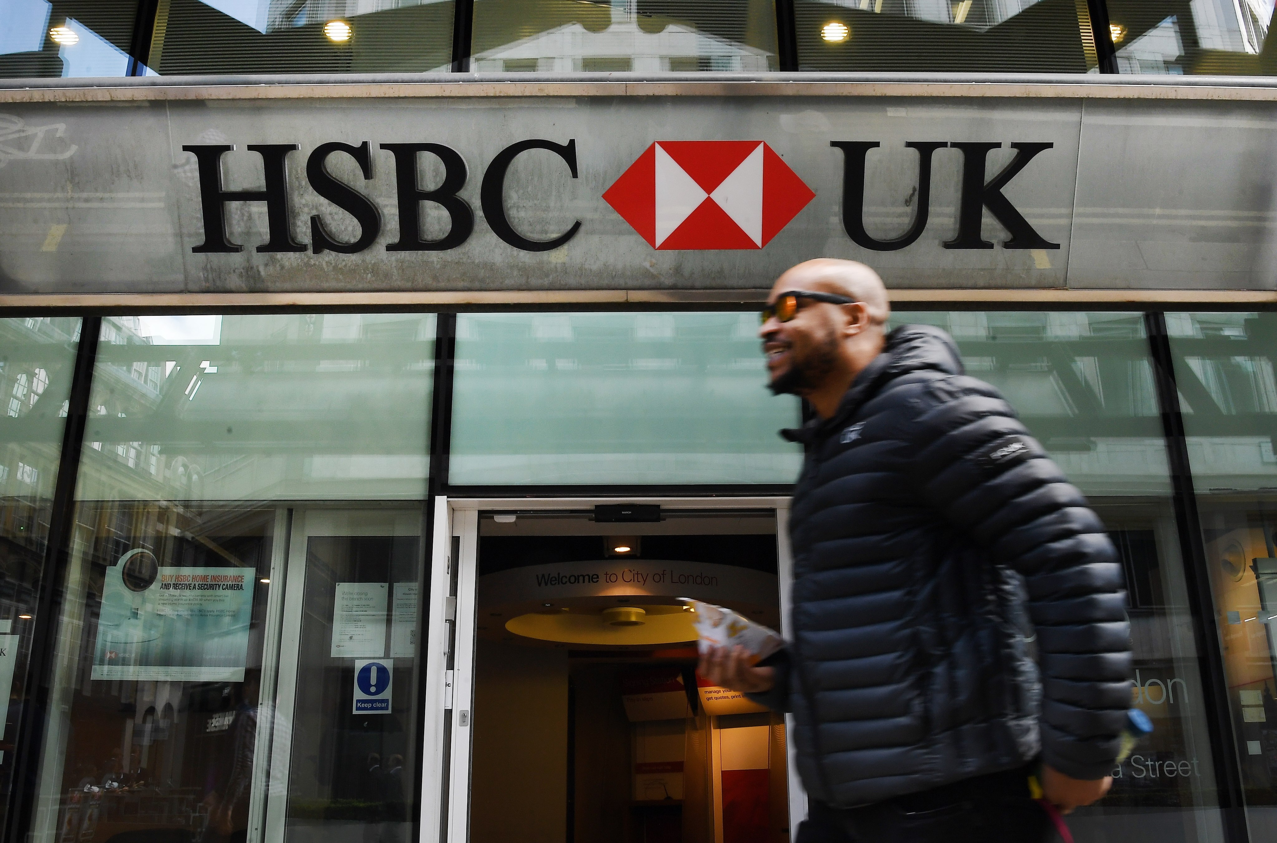 A pedestrian walks past an HSBC branch in London on Tuesday. Photo: EPA-EFE