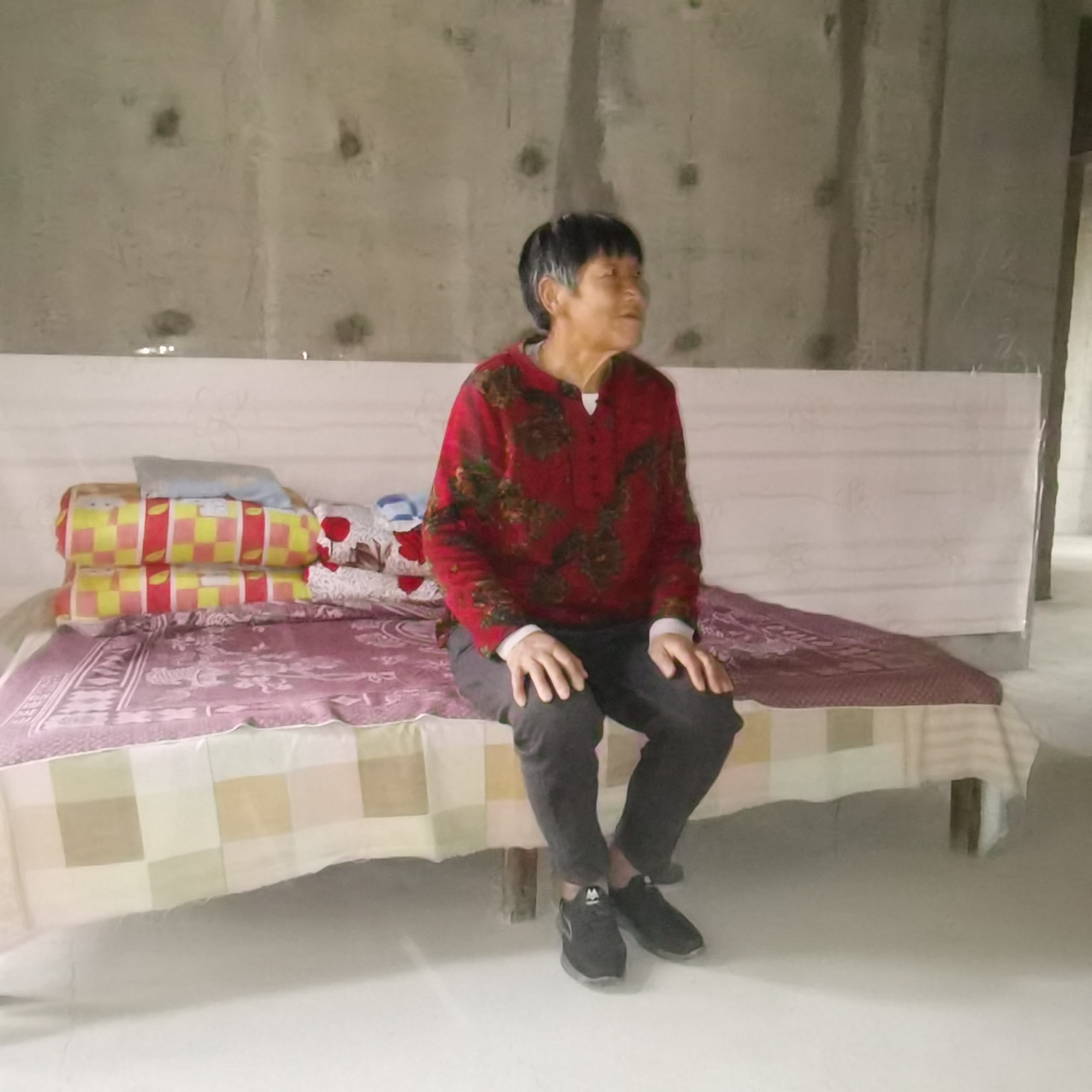 Unfinished flat owner Li Zhu’e is elderly and has a serious injury after a car accident, so the trek up and down 13 levels of stairs takes its toll. Photo: Li Zhu’e