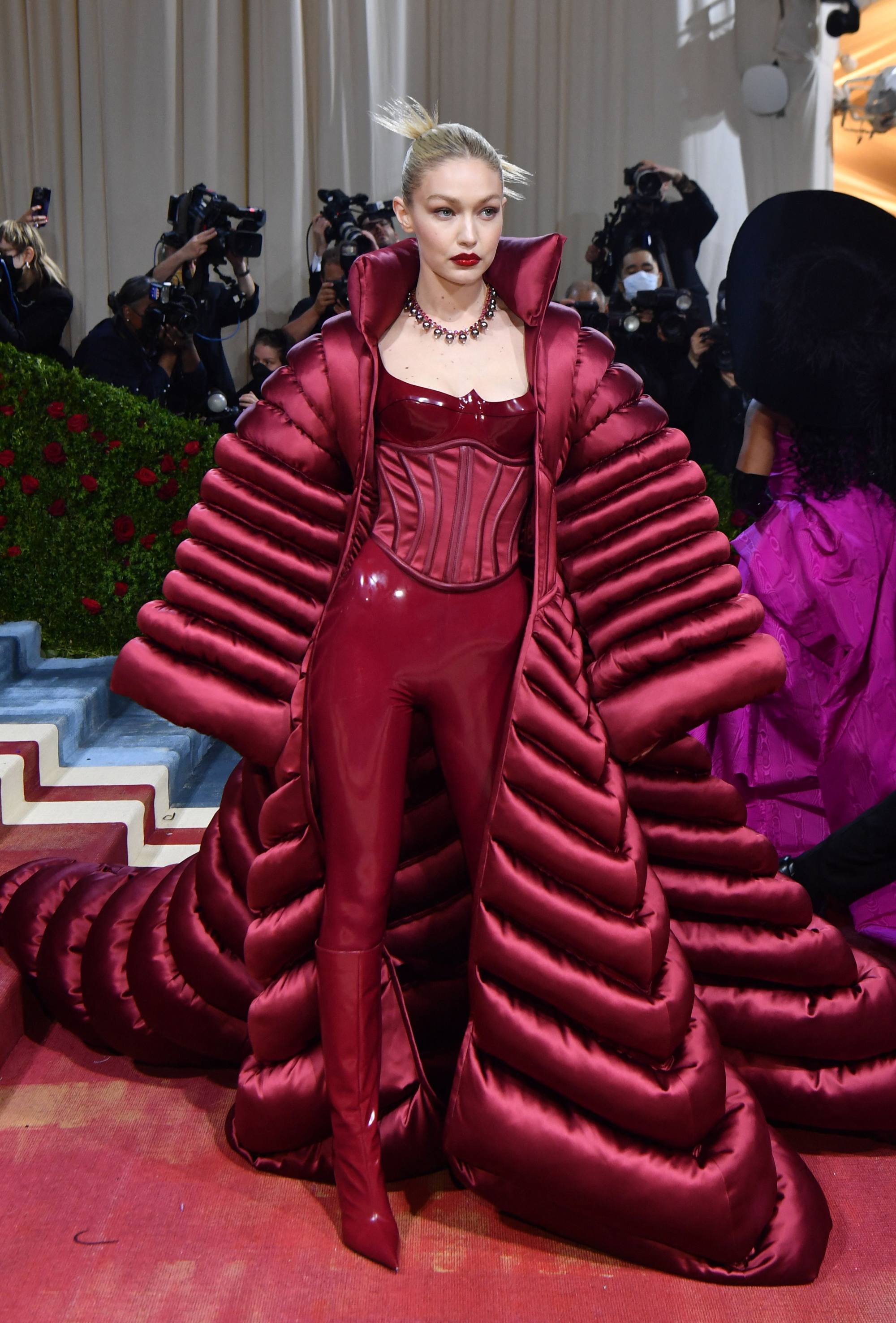 Model Gigi Hadid dons a bold burgundy puffer opera coat as she arrives for the 2022 Met Gala at the Metropolitan Museum of Art. Photo: AFP