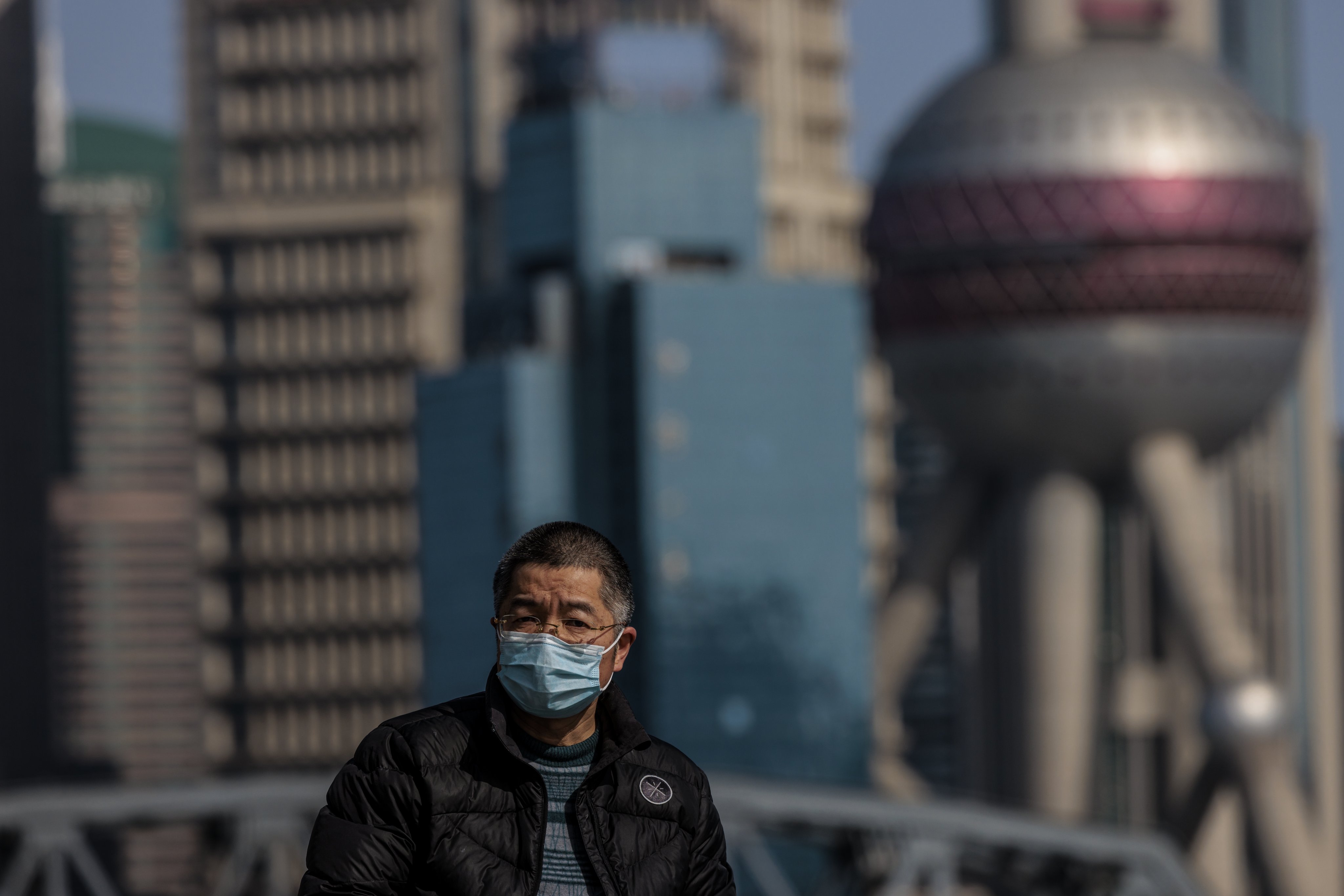 A man is seen with the Shanghai tower in the background, on March 29. The city hopes to see lockdowns end soon. Photo: EPA-EFE/