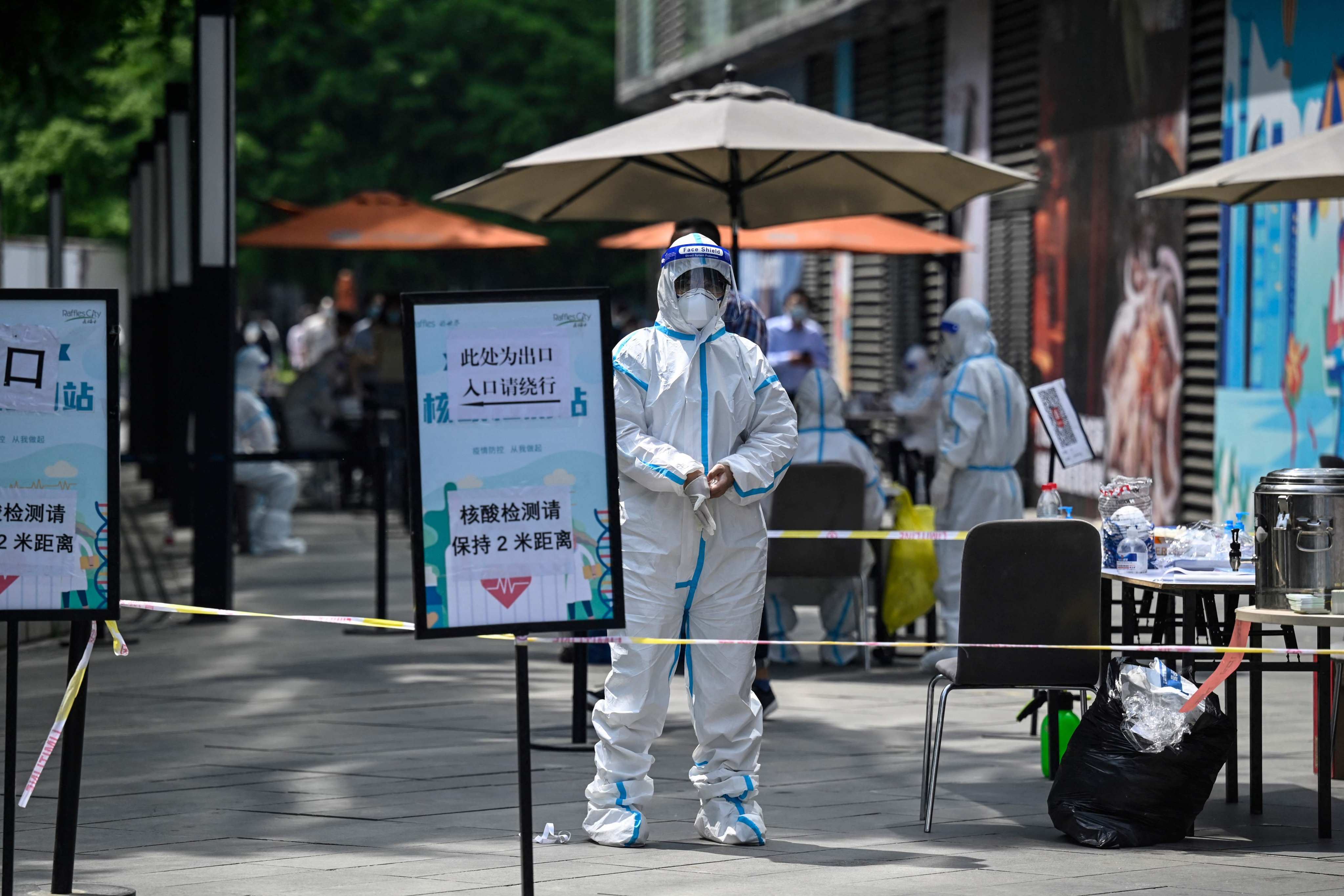 A health worker wearing personal protective equipment stands at a Covid-19 testing site outside a shopping centre in Beijing on Thursday. Photo: AFP