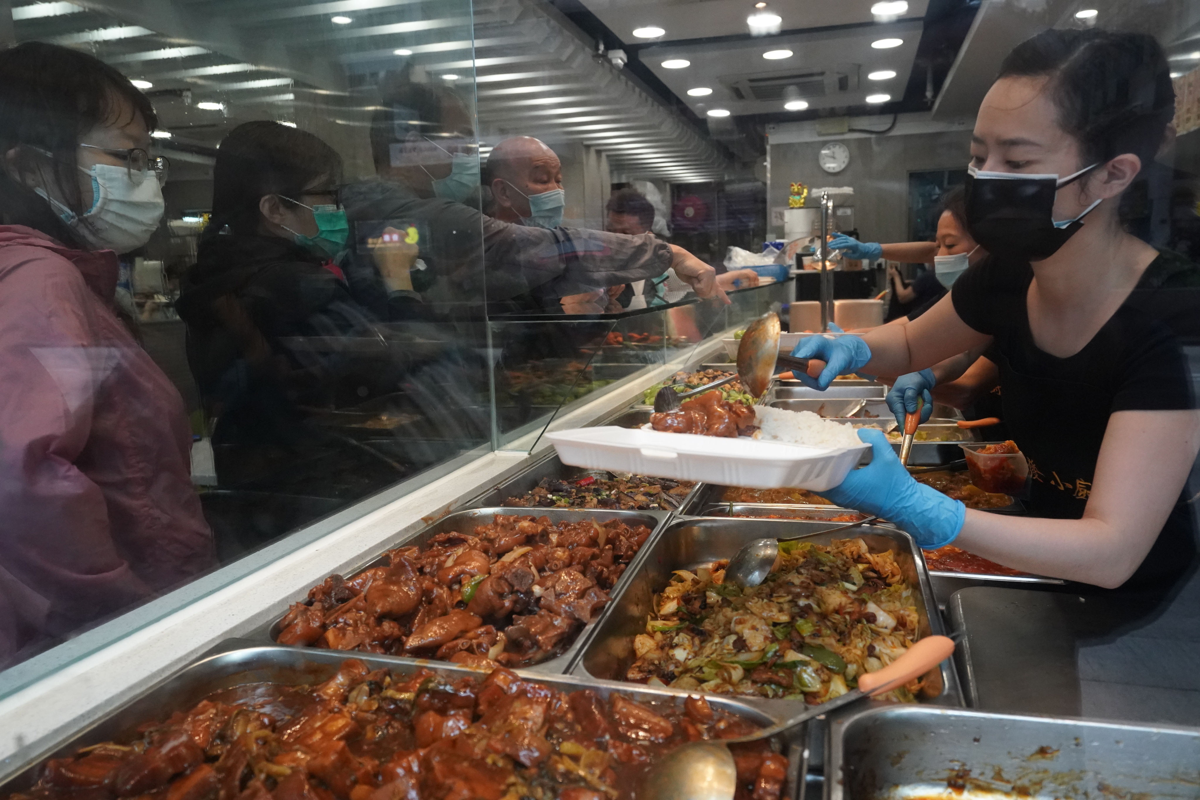 Customers line up to order a “rice with two choices of sides” in Yau Ma Tei during the fifth-wave Covid-19 outbreak. Photo: Felix Wong