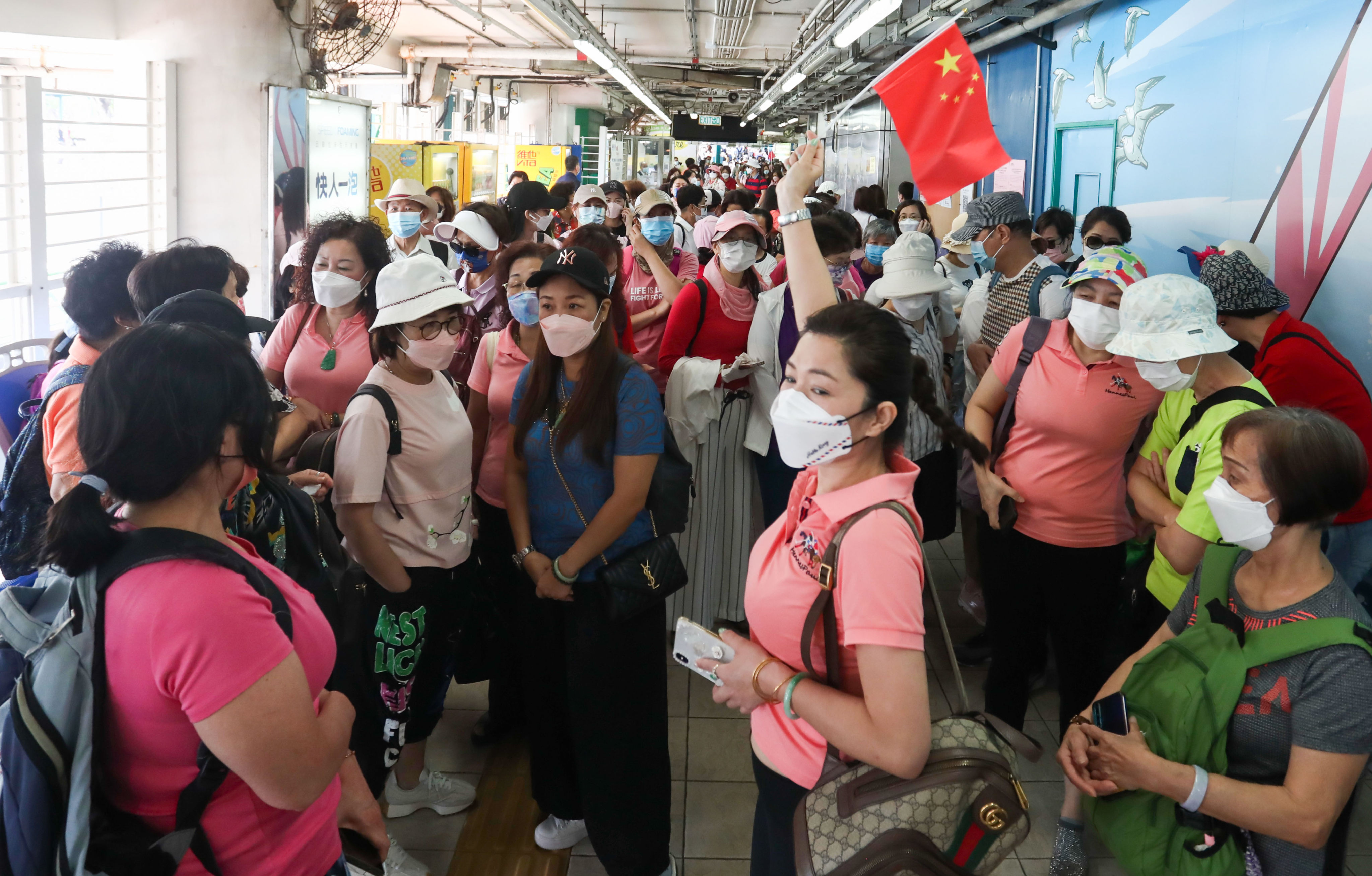 Crowds at the ferry pier headed for Cheung Chau, as thousands flocked there to enjoy the first long weekend since authorities further eased Covid-19 measures. Photo: Jonathan Wong